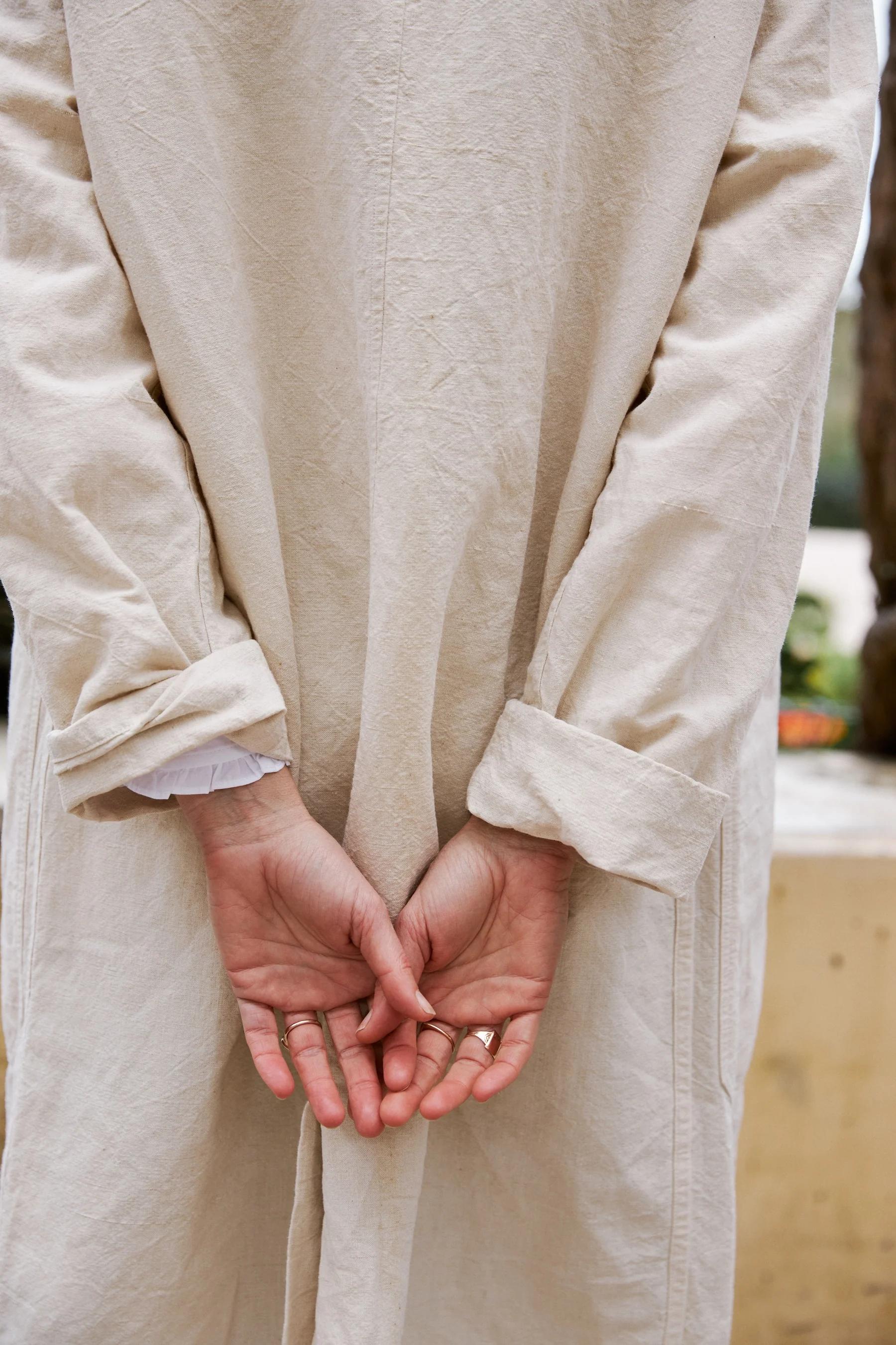 Three Pocket Coat from behind with the sleeves rolled up. 