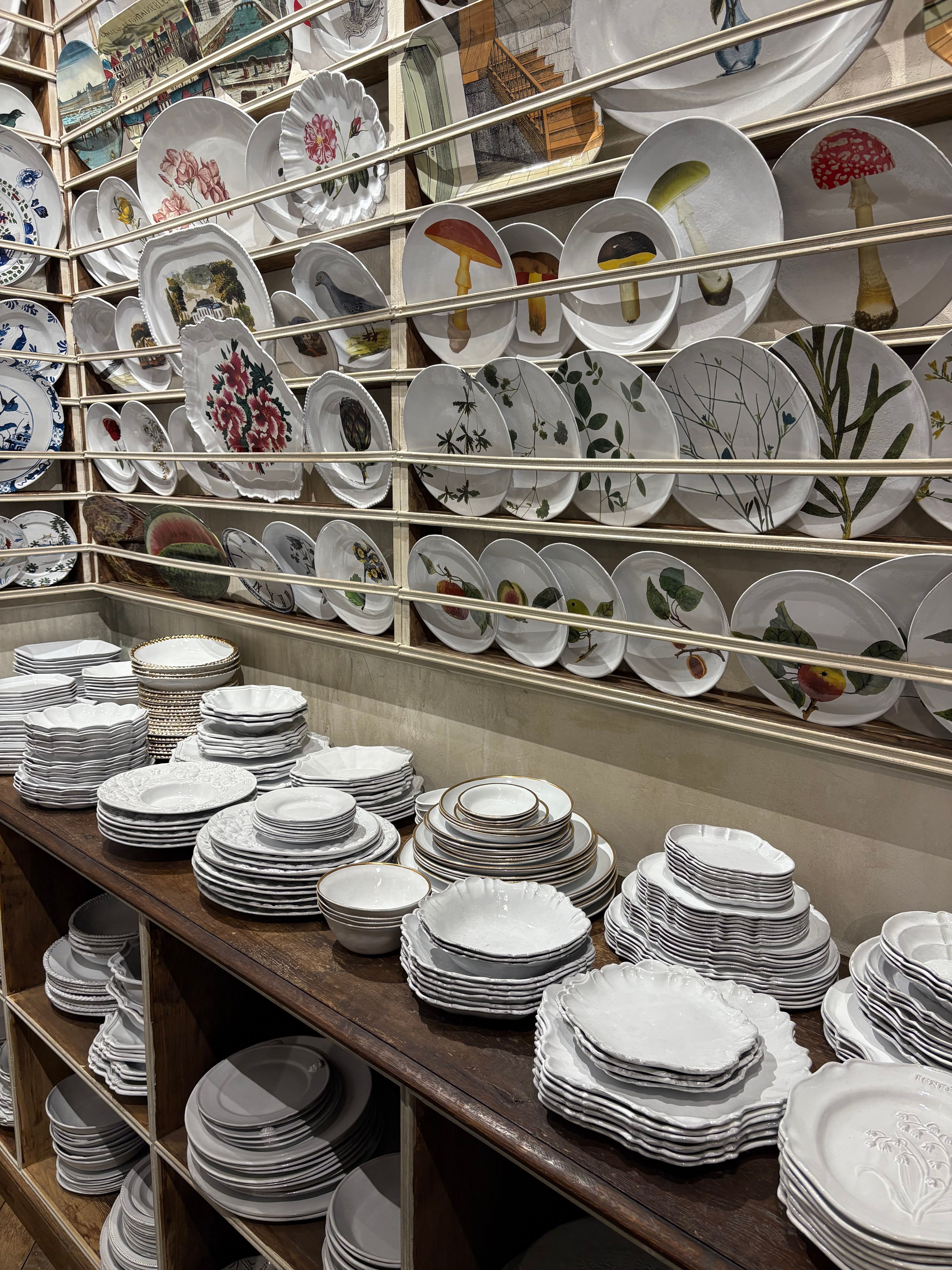 walls are covered in a display of white plates and platters 