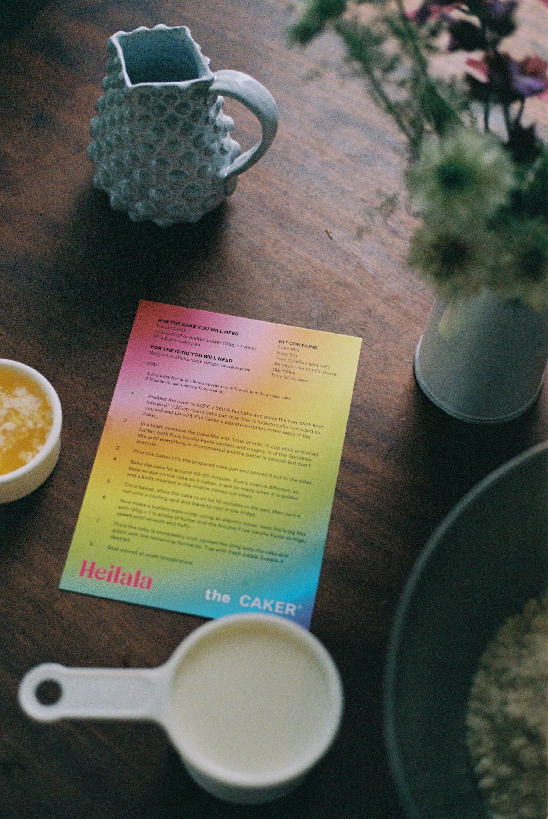 The Caker recipe card on a dark timber table 