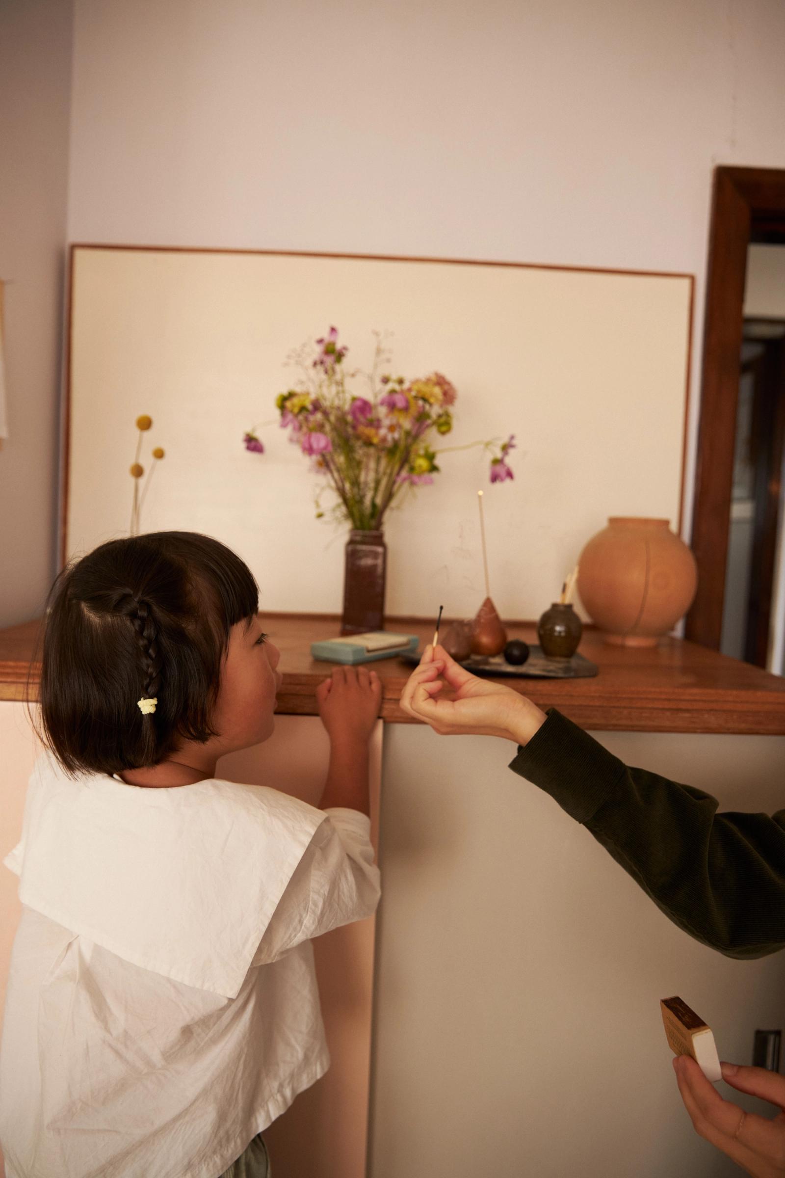 lighting a incense stick with a match