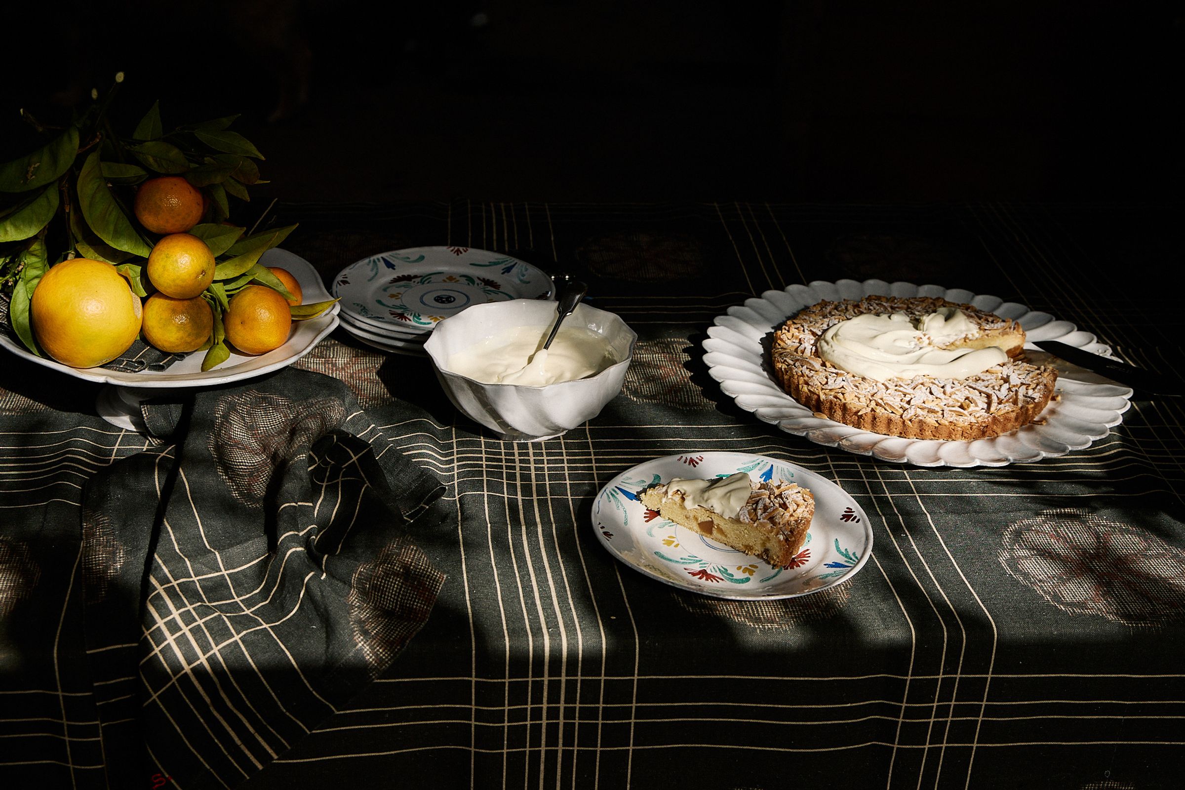 whole table in view of cake, plates and fruit bowl