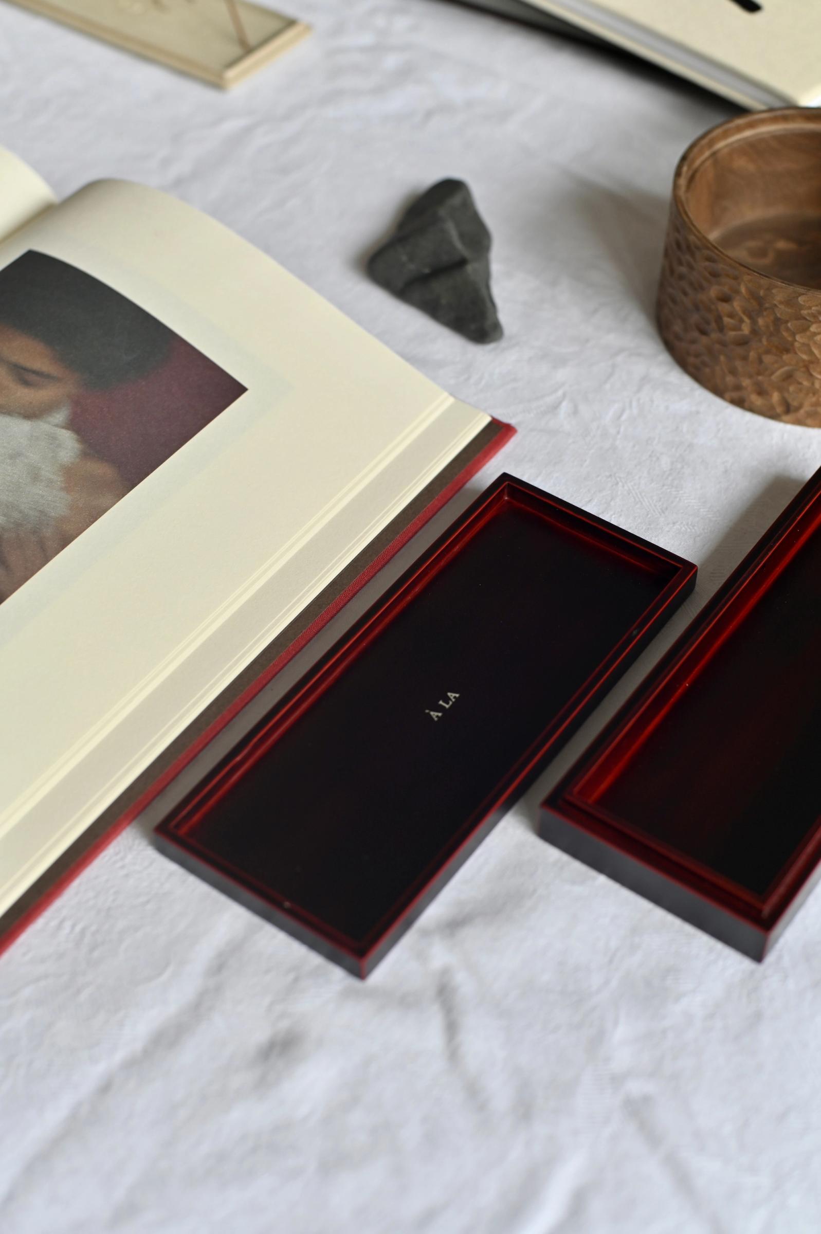 a table covered in white linen is peppered with books and boxes