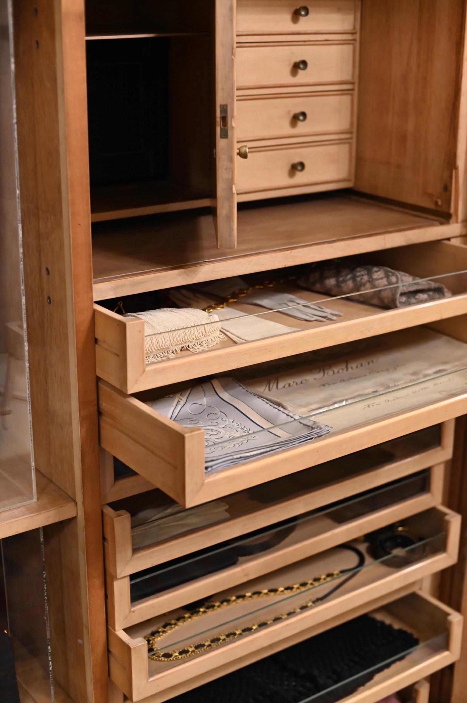 the wardrobe featuring drawers for silk scarves and gloves