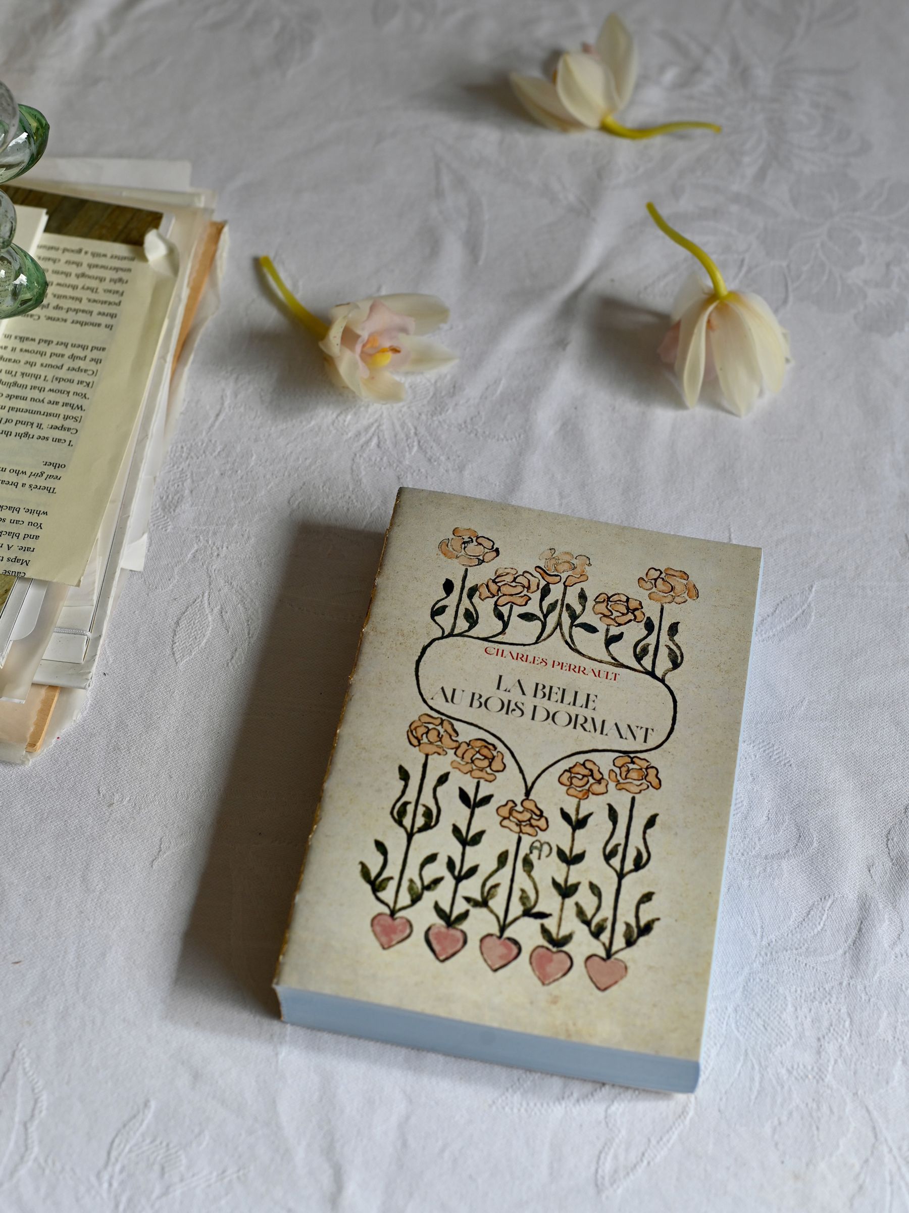 Sleeping Beauty Notebook on white tablecloth in natural light
