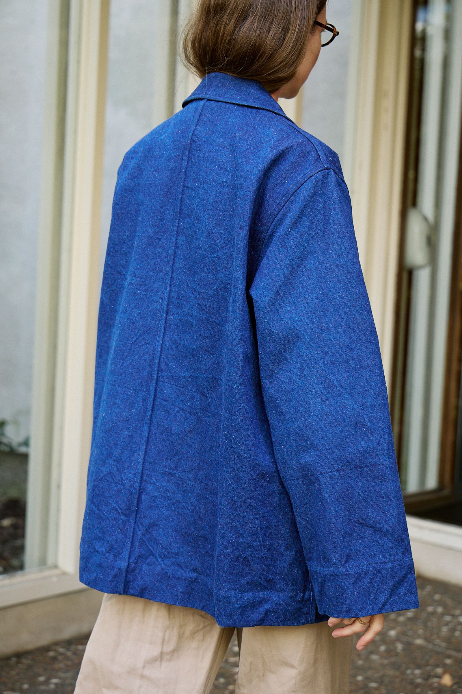 Big Jacket in Linen Denim Blue photographed from behind as model walks away