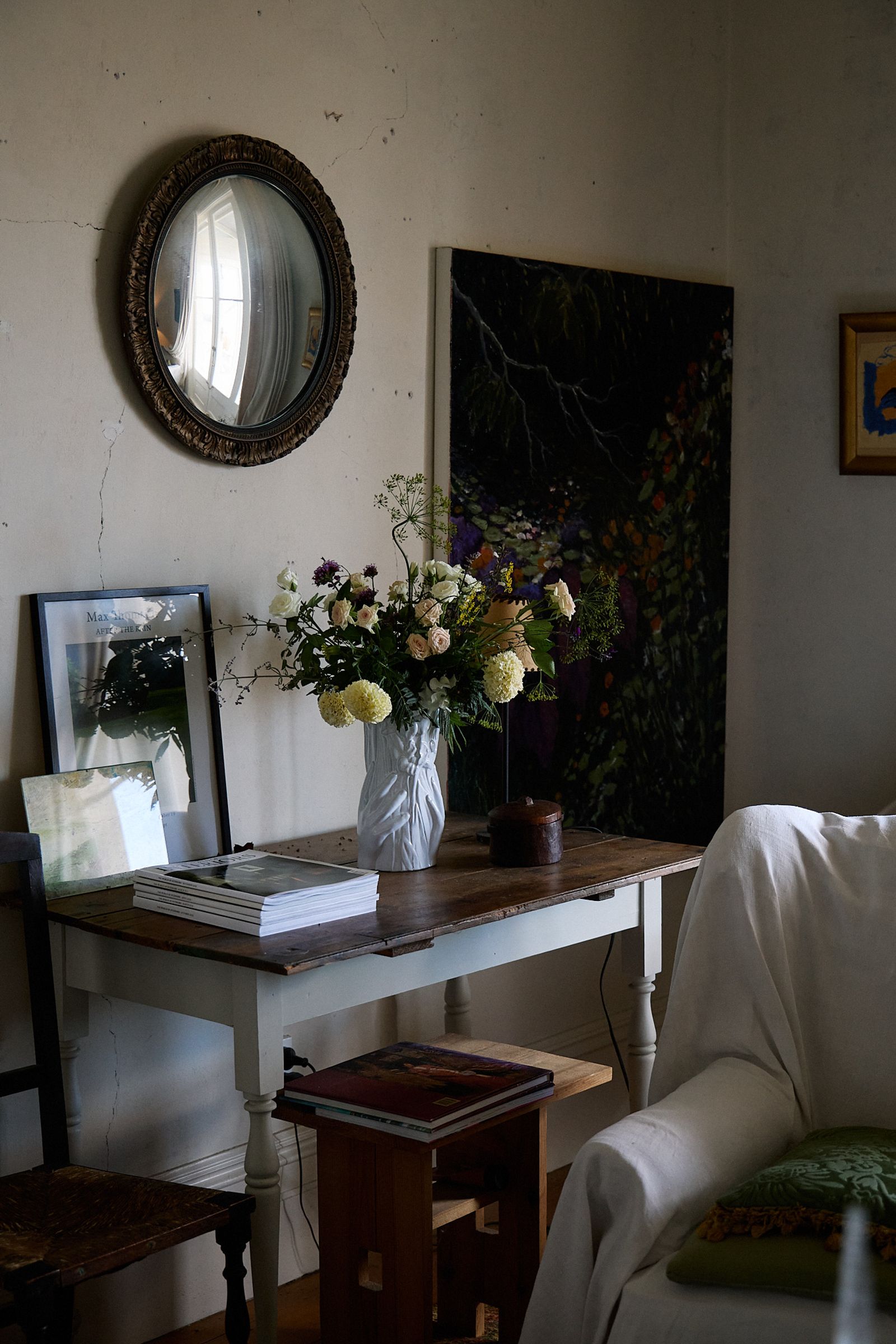 living room with fresh flowers on side table and armchair
