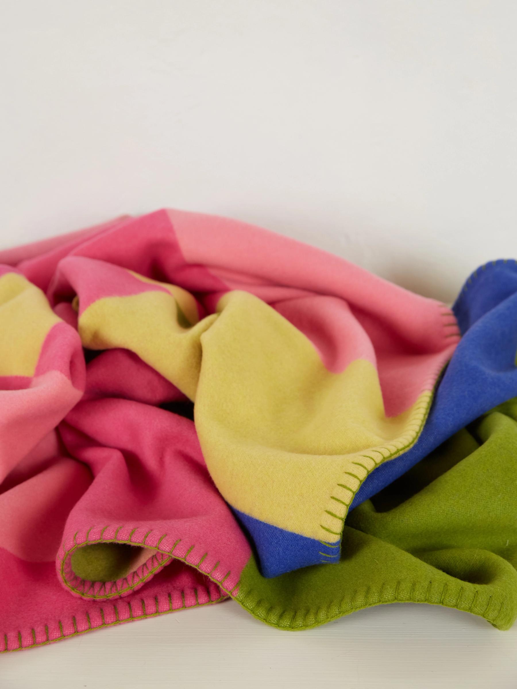 a crunched up throw featuring pink yellow green and blue colours