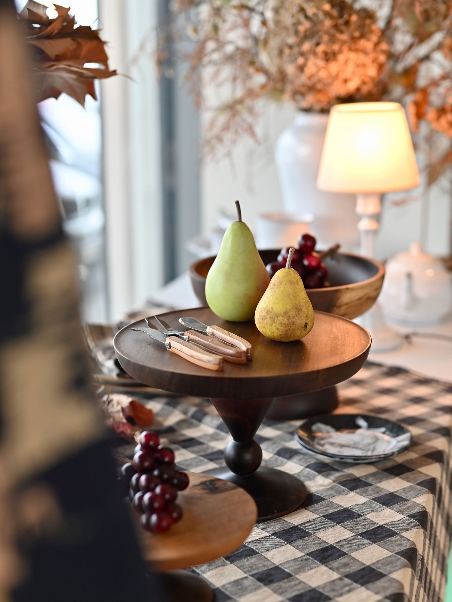 Brown and Green  pear with short stem on wooden tray