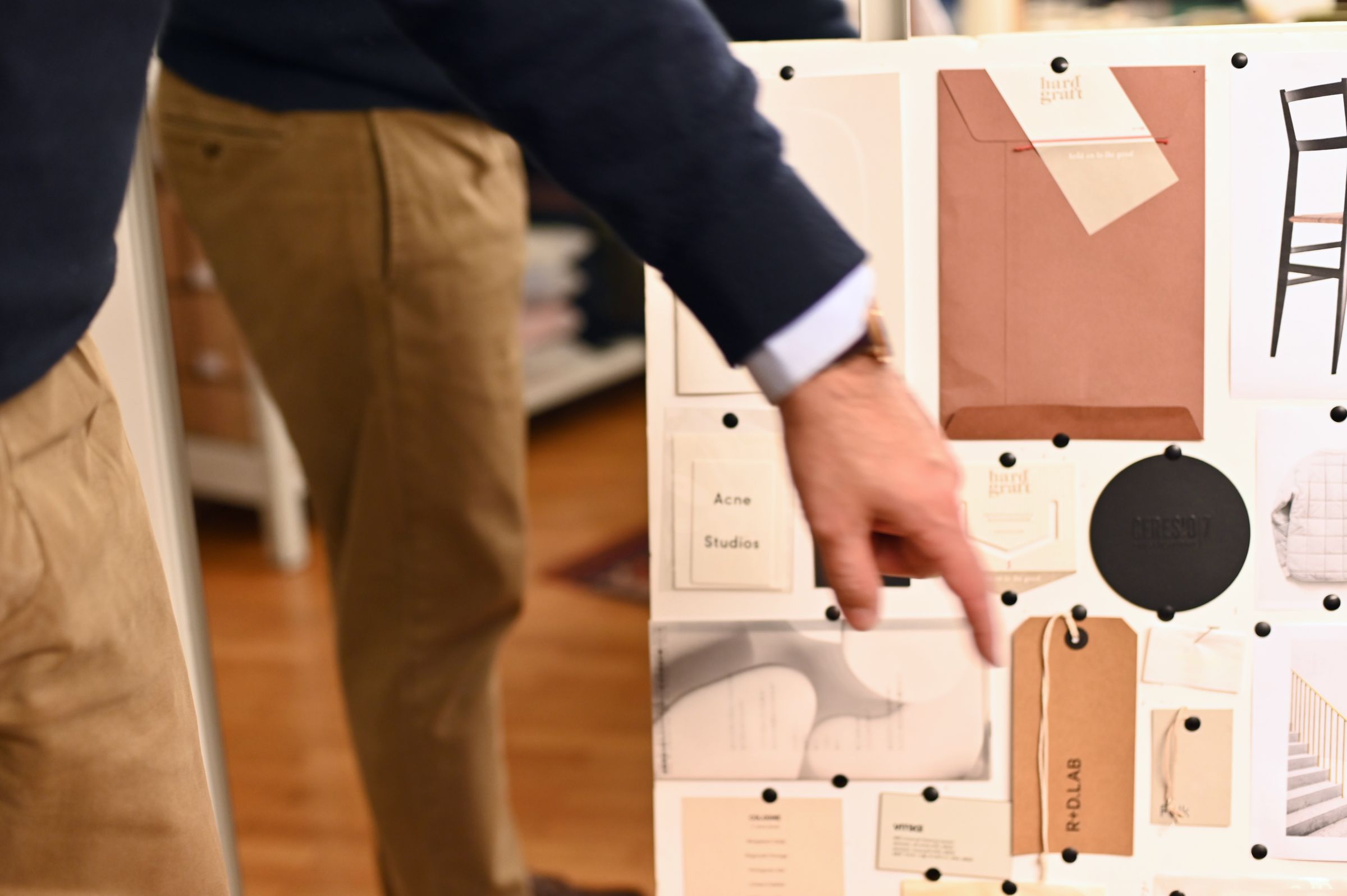 Jay's hand points to his moodboards for R+D LAB