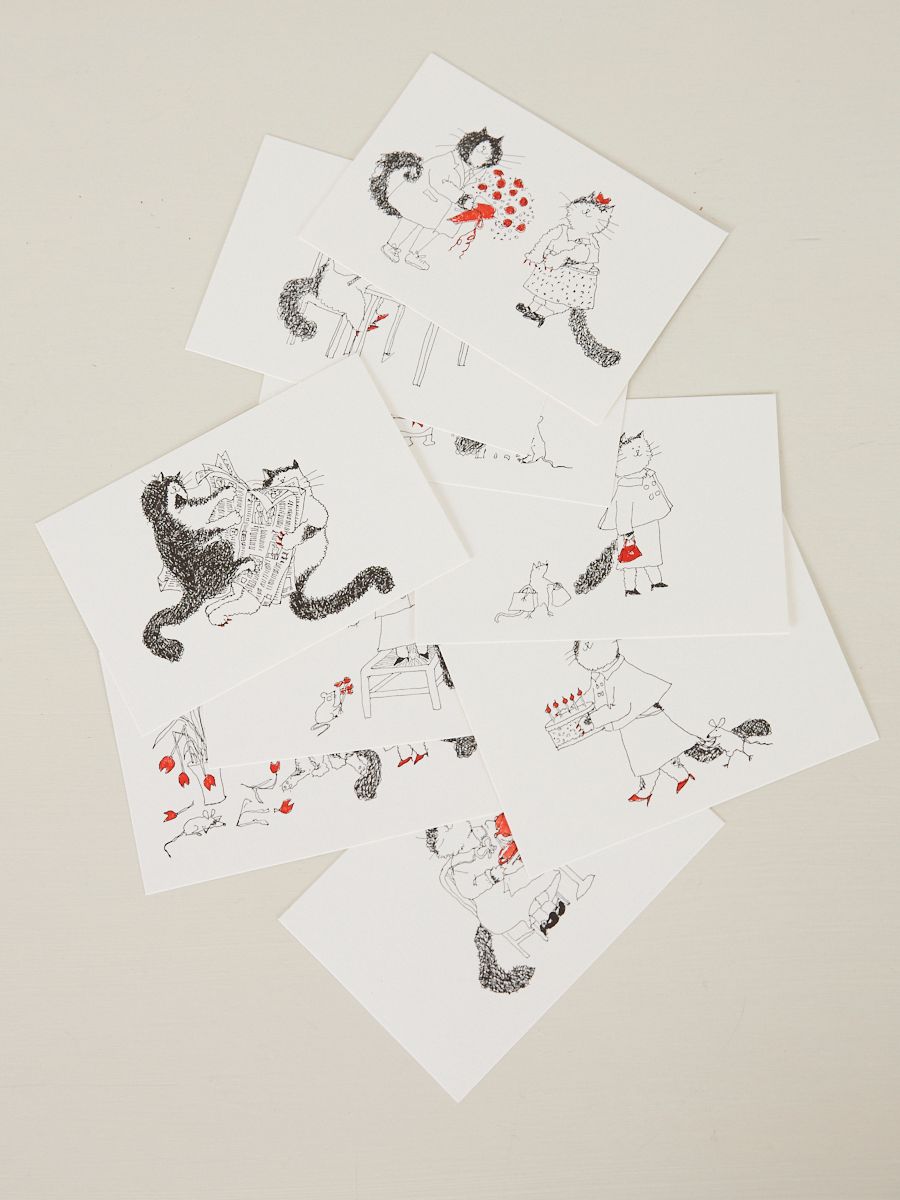 10 illustrated cards are scattered on a table featuring cats and flowers