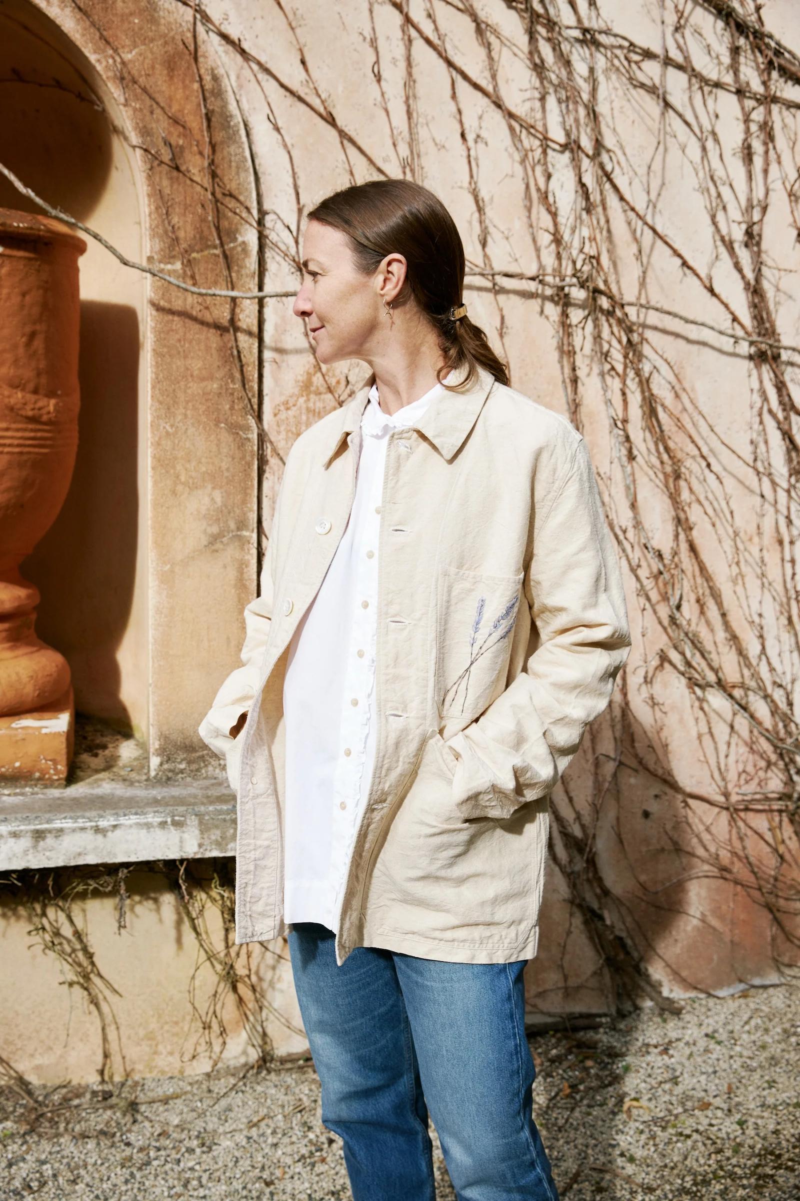 Three pocket jacket in cream with a lavender stem hand embroidered onto the pocket.