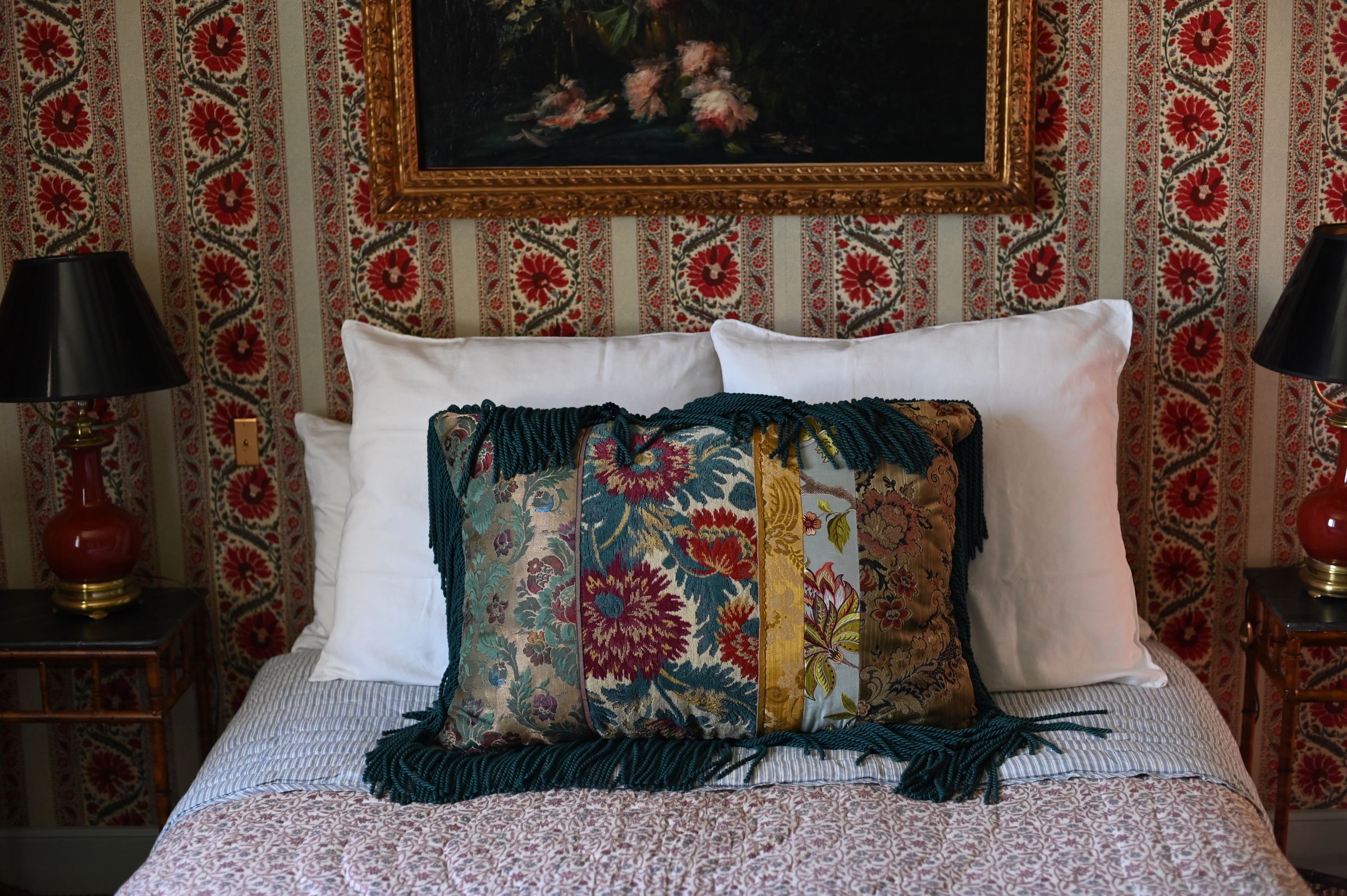 the bed covered in pillows and quilt