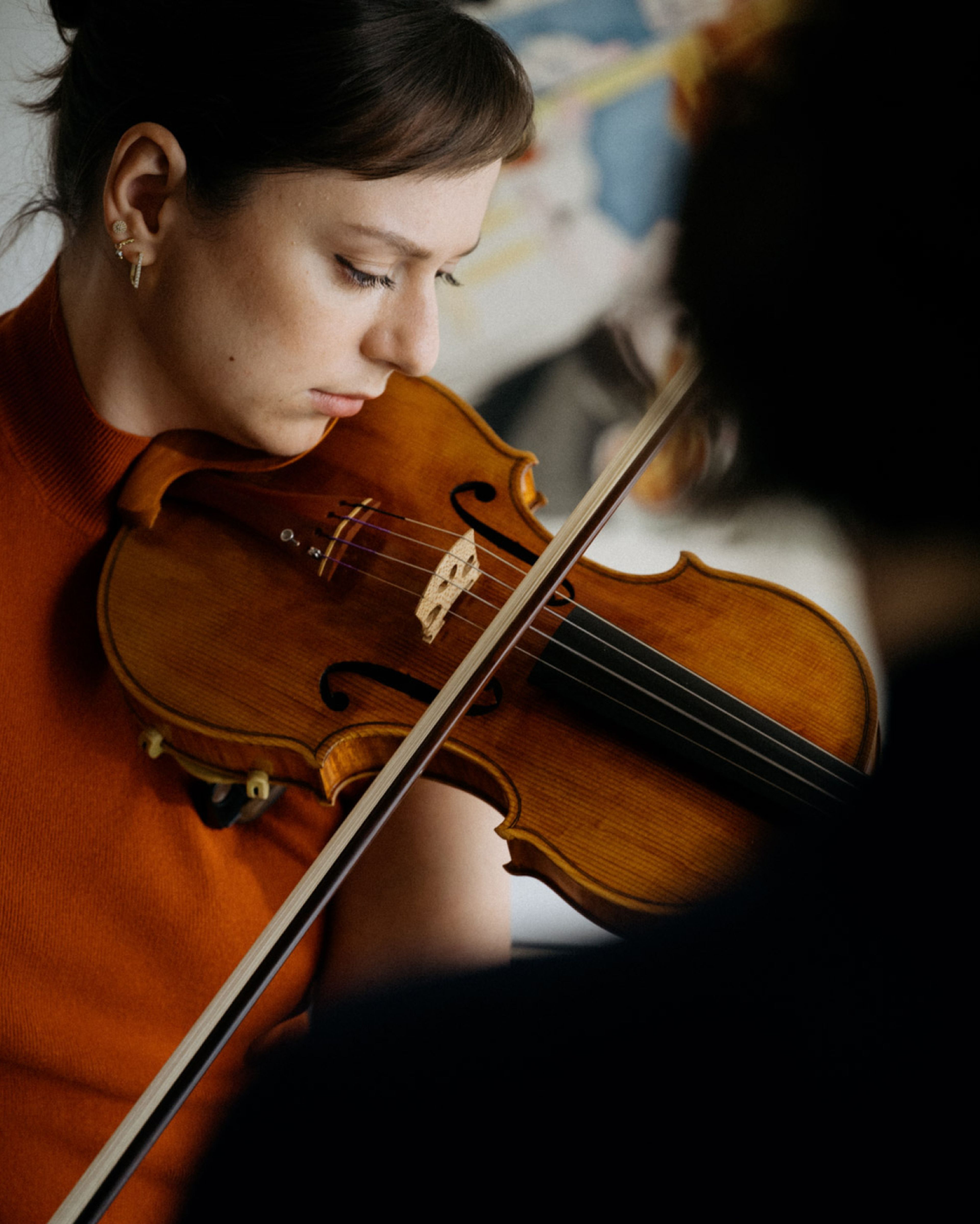 Woman playing the violin with focus