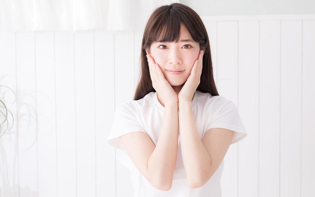 A person holding their face