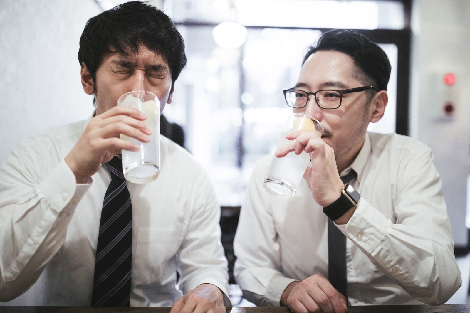 Two salarymen having a drink together