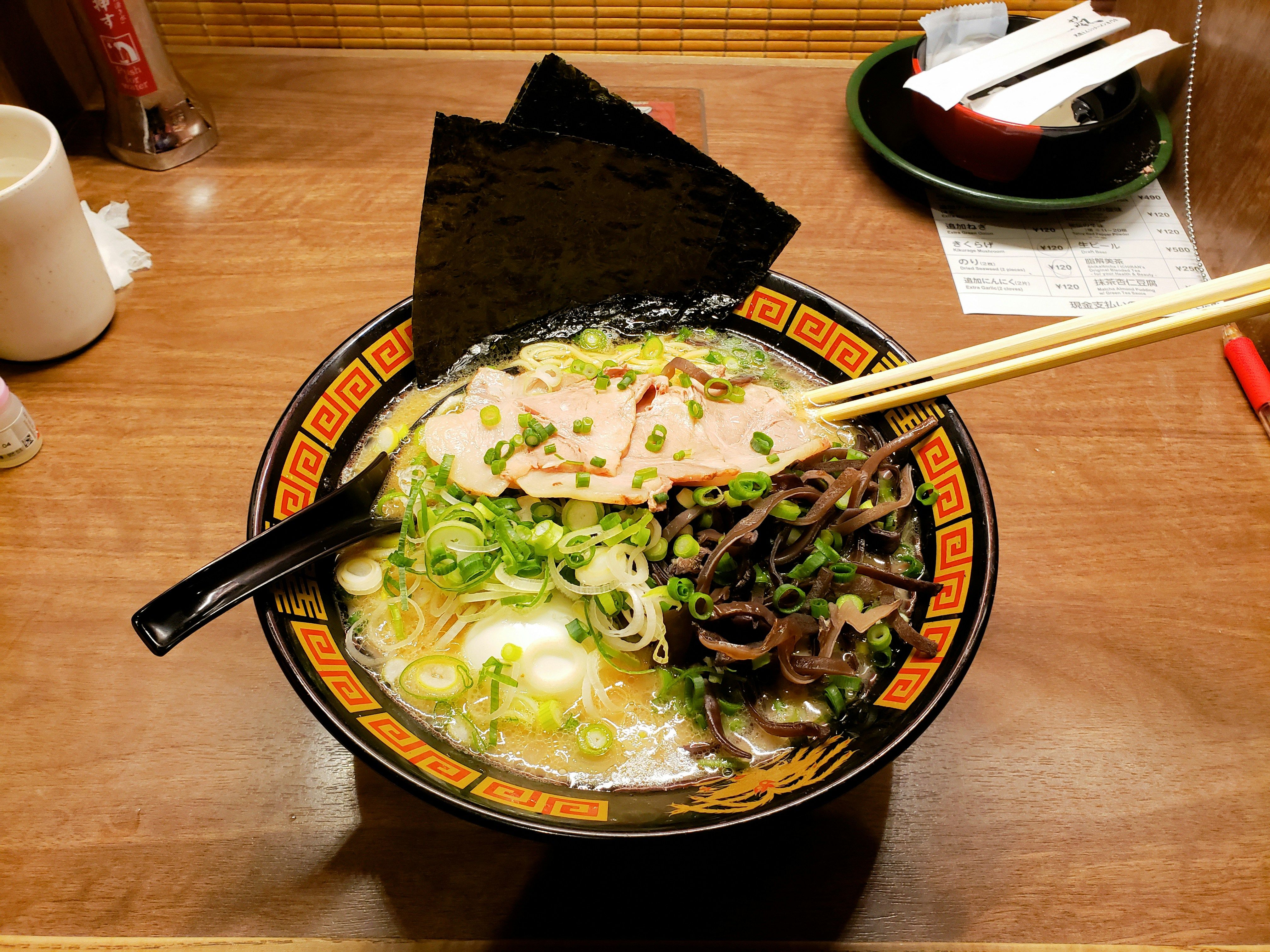 A bowl of ramen topped with pork