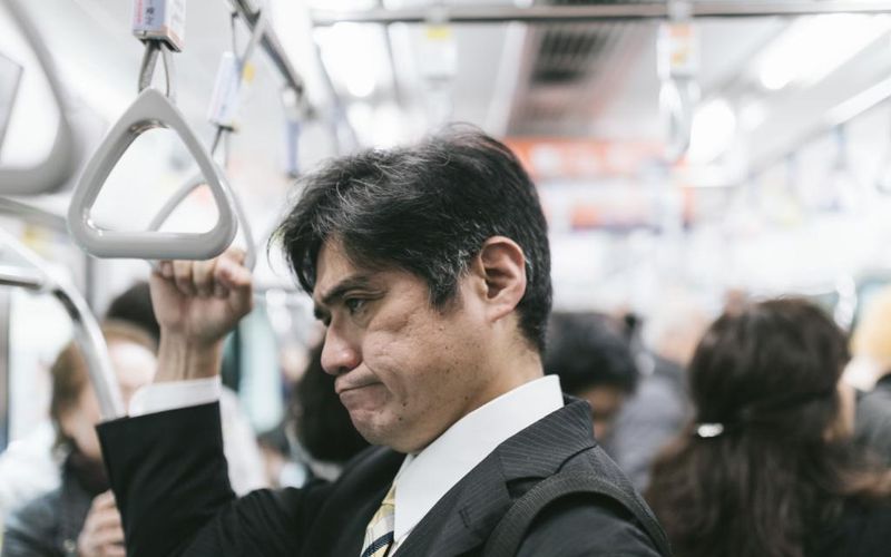 Man in the train looking annoyed