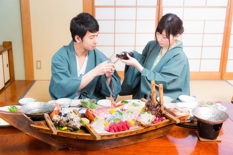 A couple staying at a ryokan, with a boat full of food