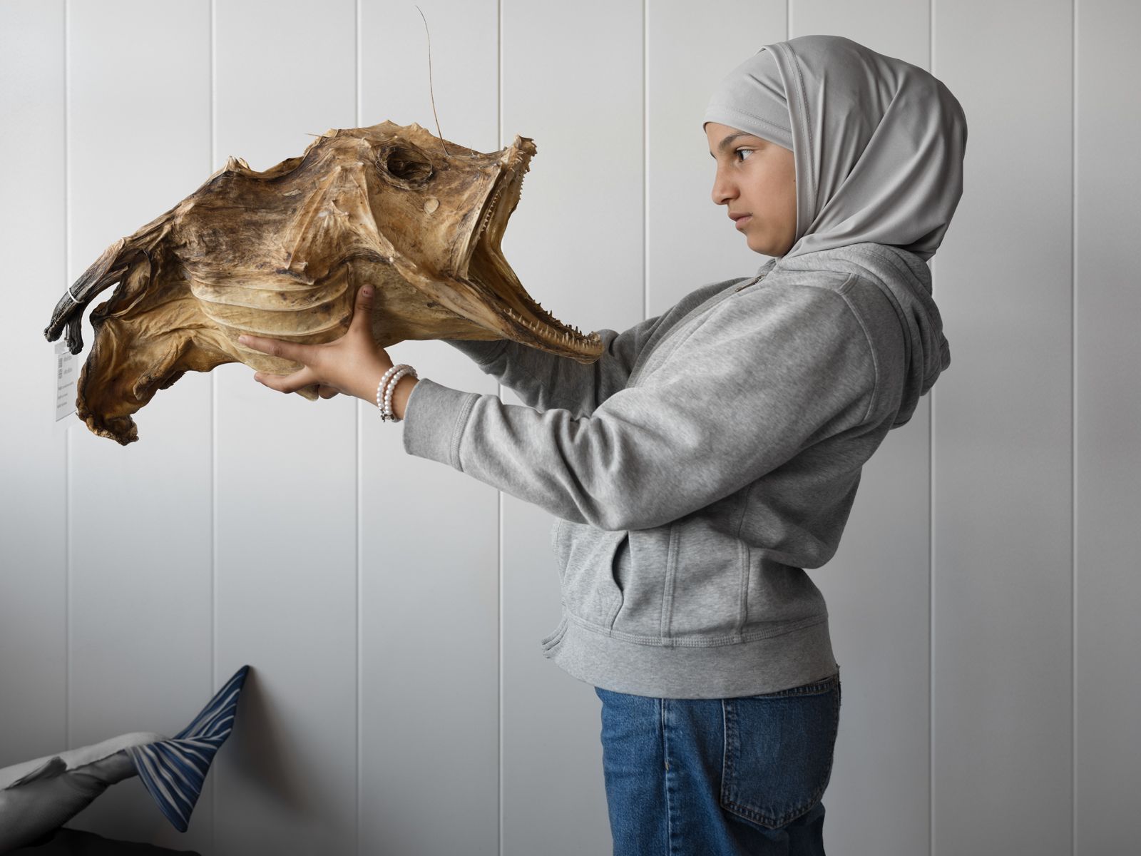Jullanar Holding a Monkfish after Leaving Syria, Norway, 2023