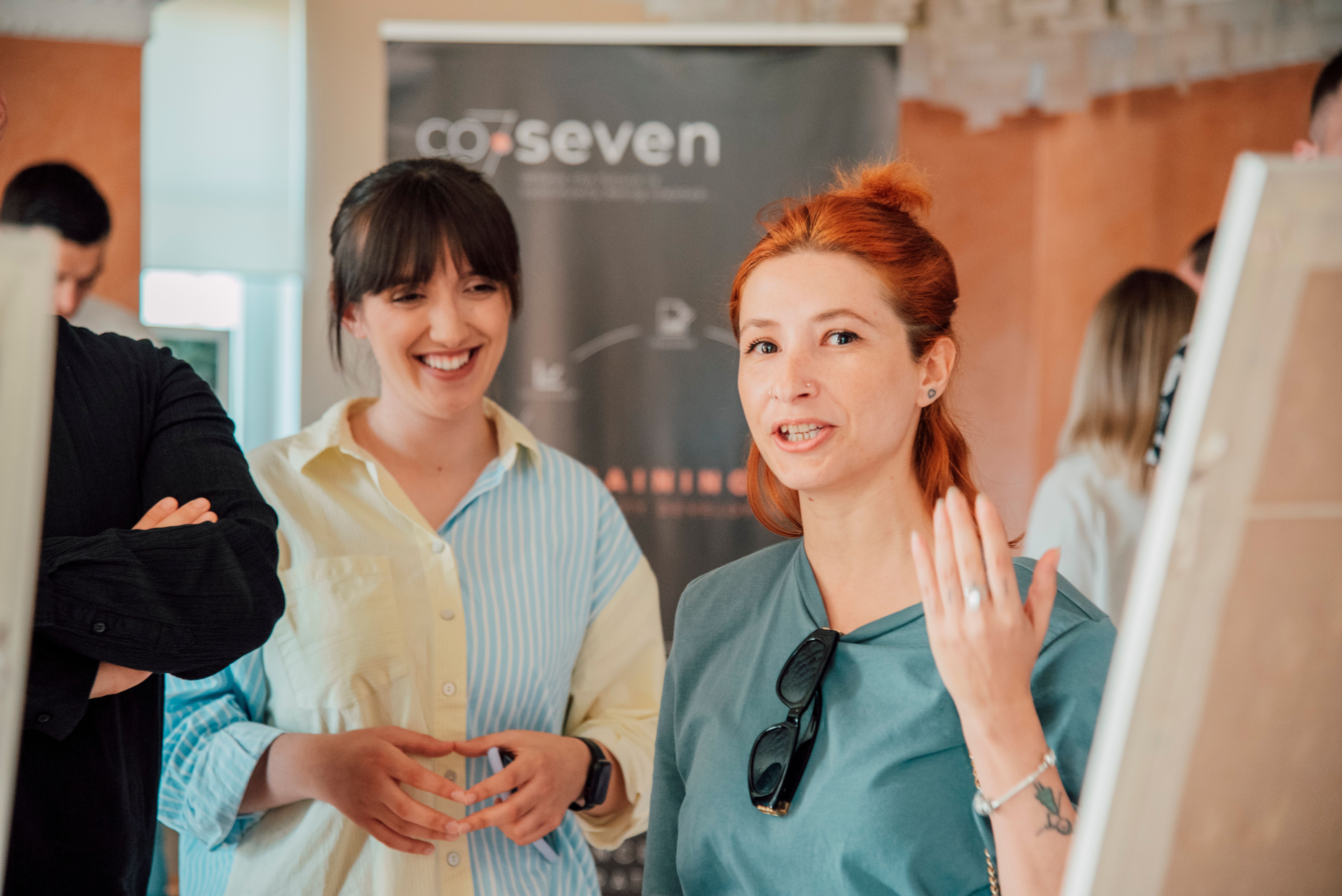 Two women engaging in a lively discussion during a workshop session.