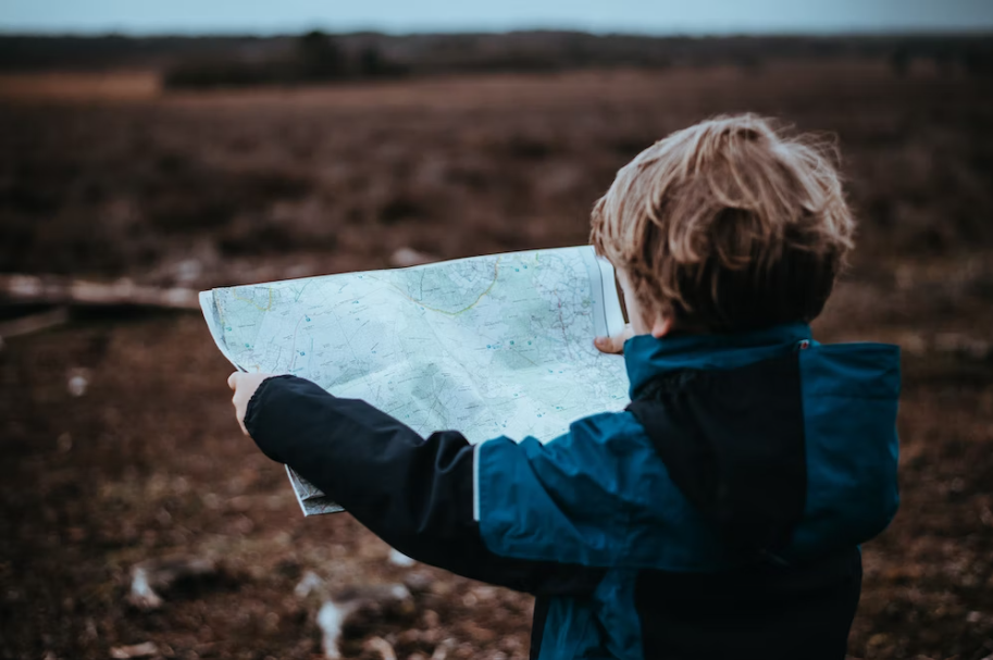 A young boy with a map.