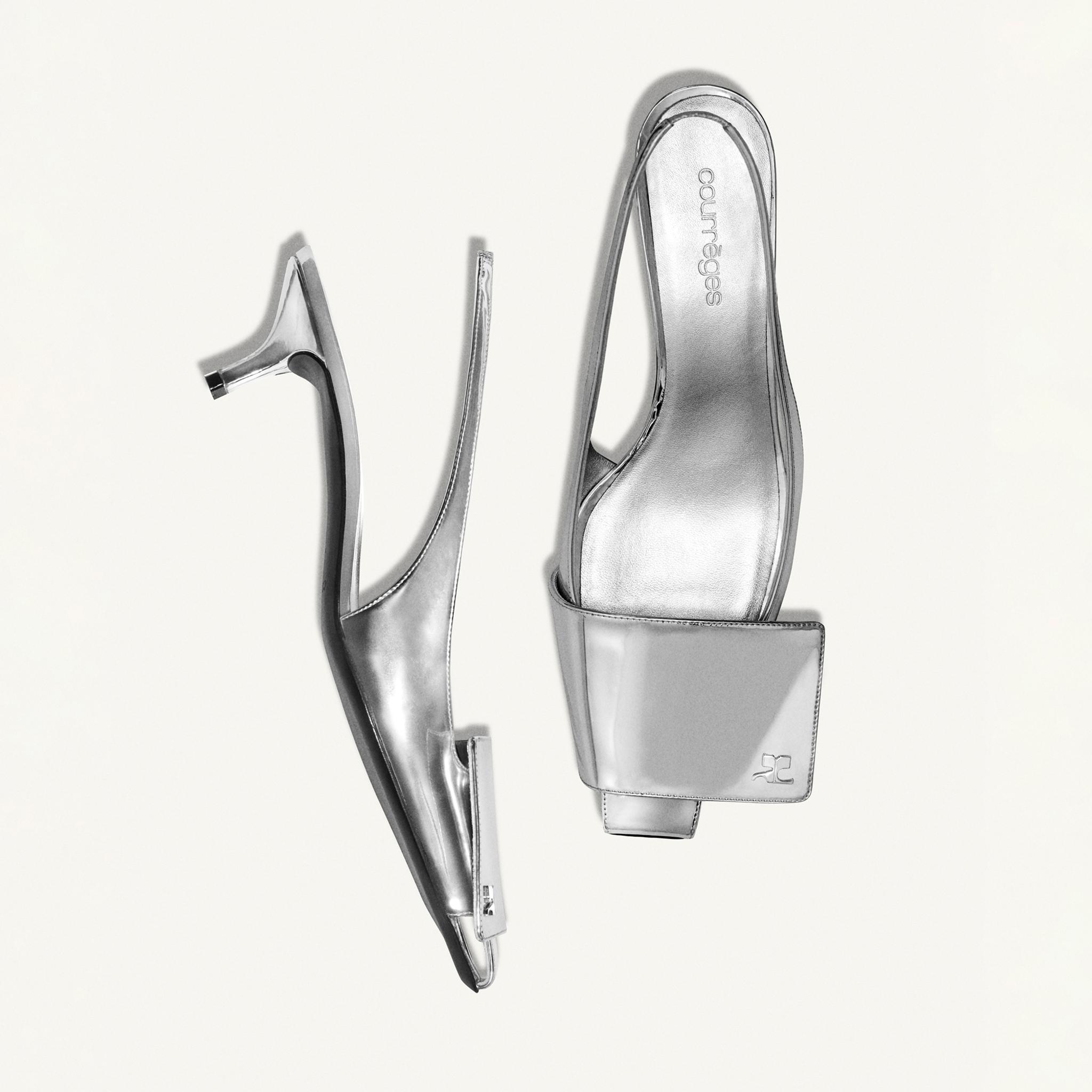 Elegant silver high-heeled shoe by Courrèges, showcased on a white background, luxury fashion.