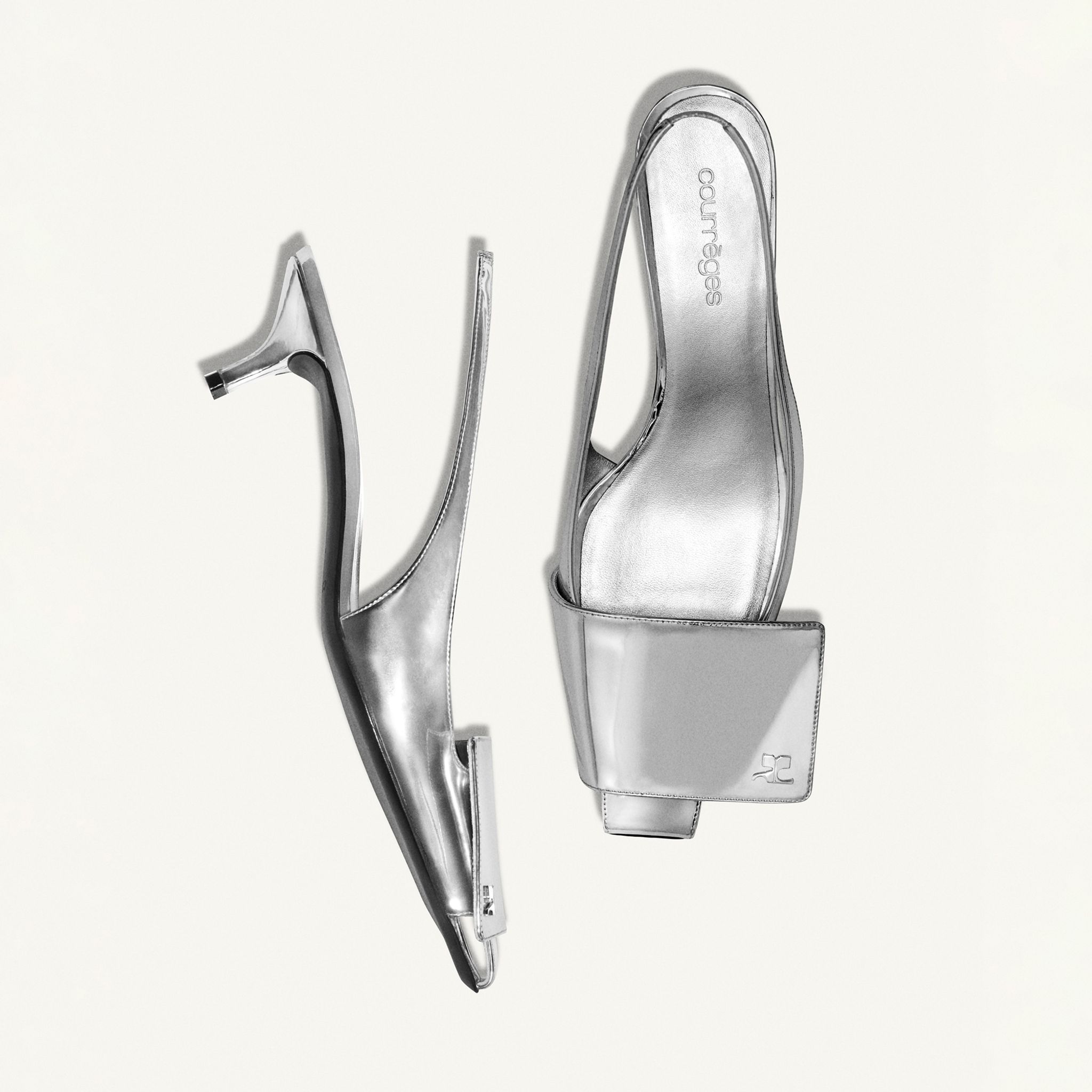 Elegant silver high-heeled shoe from Courrèges, stylish and modern for fashion-forward looks.