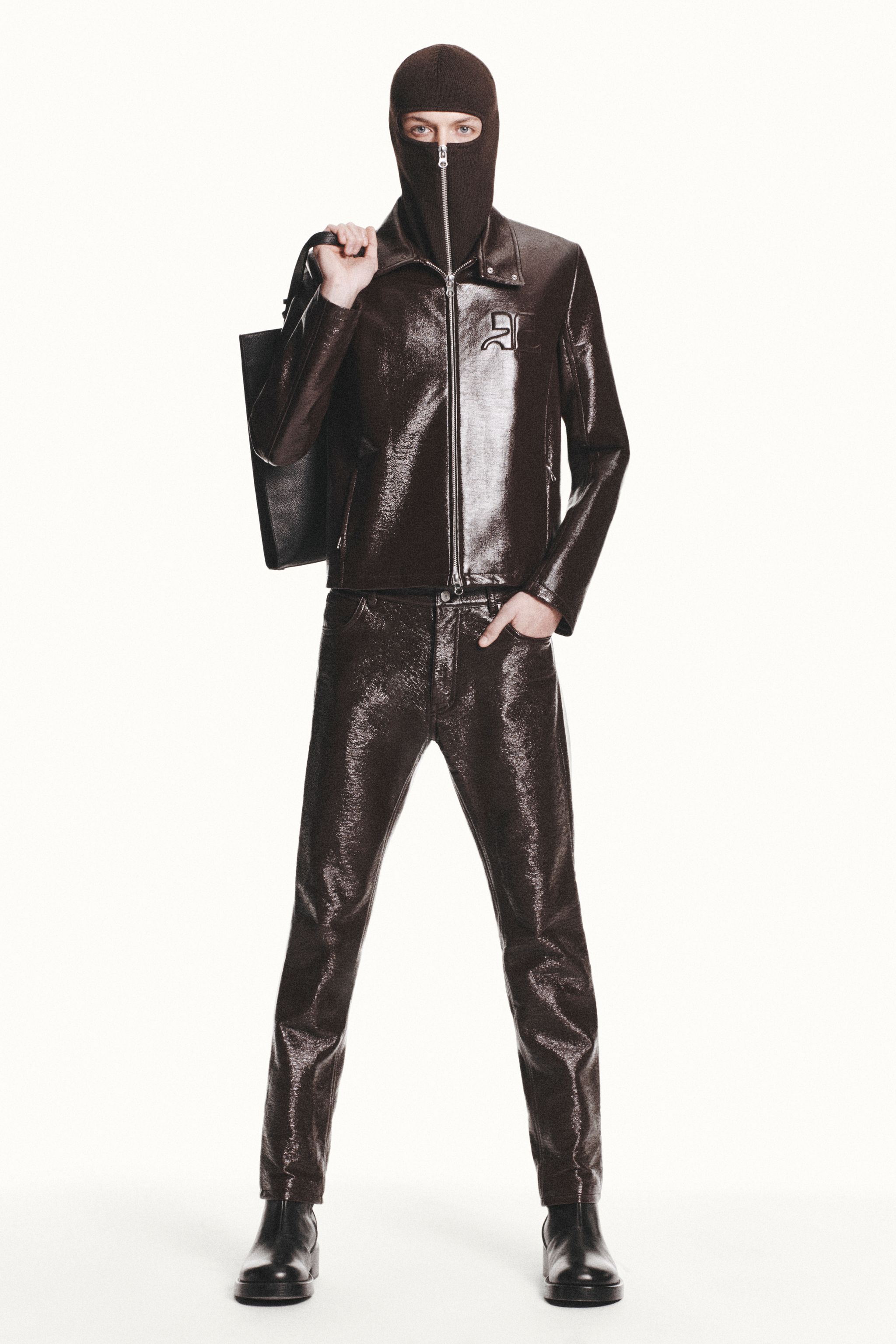 Elegant model in metallic brown leather ensemble showcasing Courrèges fashion for ecommerce.