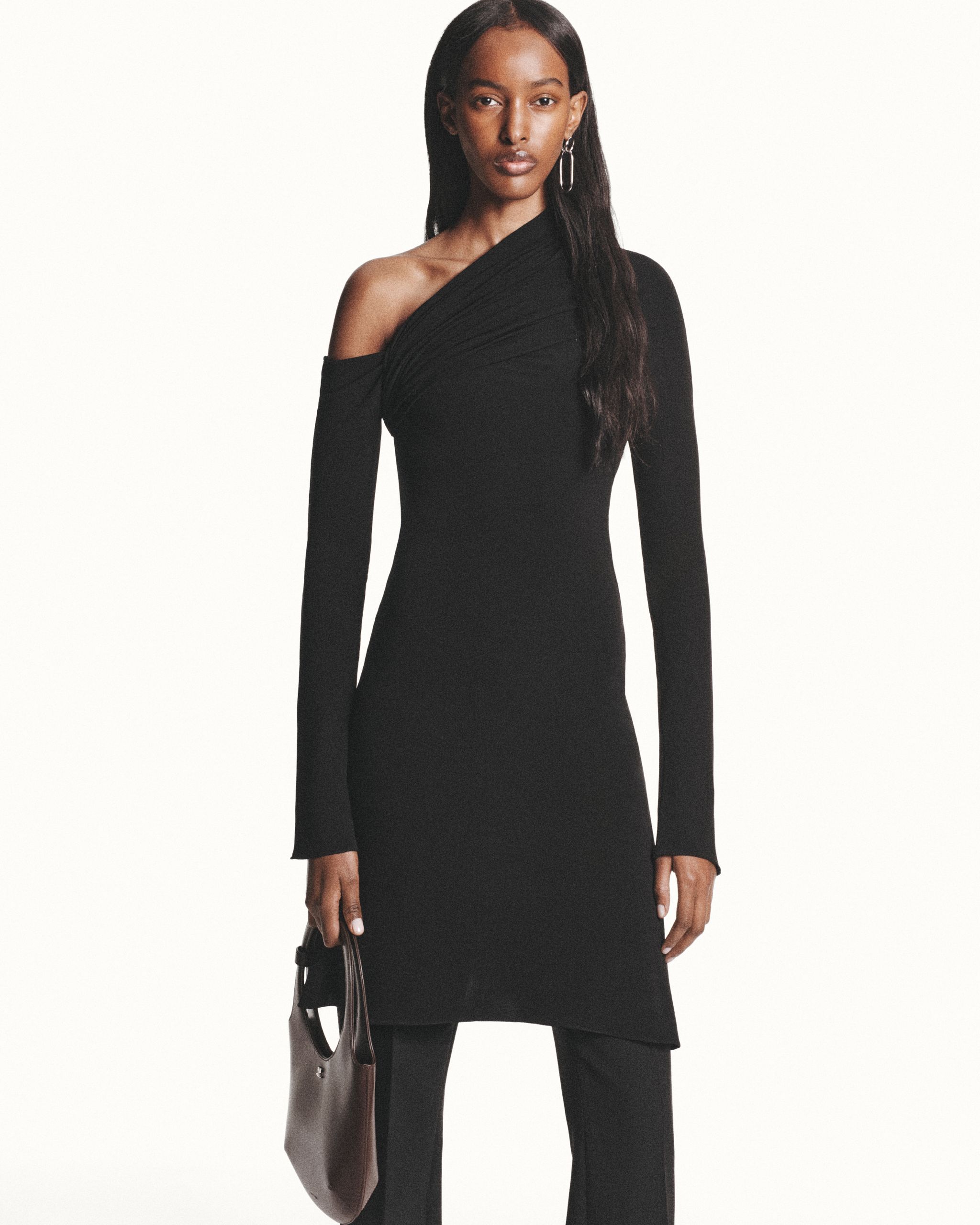 Elegant black Courrèges dress with asymmetrical shoulder design, perfect for high fashion.