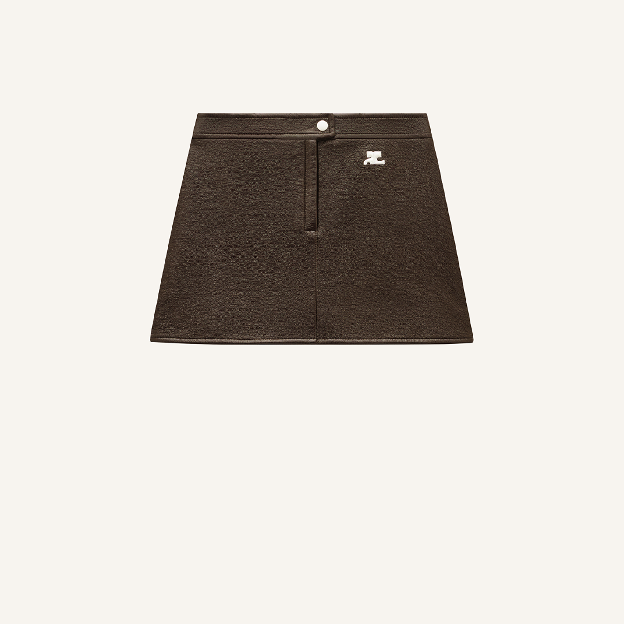 Elegant brown leather skirt from Courrèges displayed on a minimalist background for ecommerce.