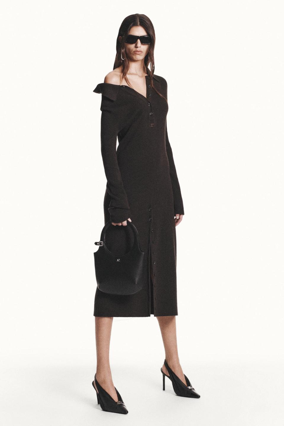 Elegant black dress with a slit, paired with high heels and stylish accessories for Courrèges.