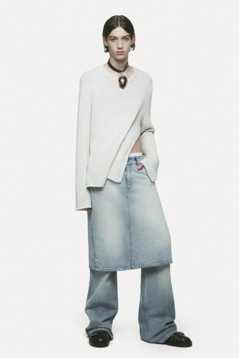 Elegant casual fashion featuring a white oversized sweater, layered with a denim skirt and wide-leg jeans, for Courrèges.