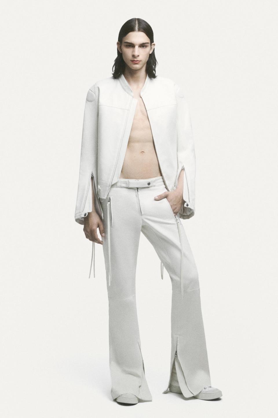 Elegant casual fashion featuring a white oversized sweater, layered with a denim skirt and wide-leg jeans, for Courrèges.