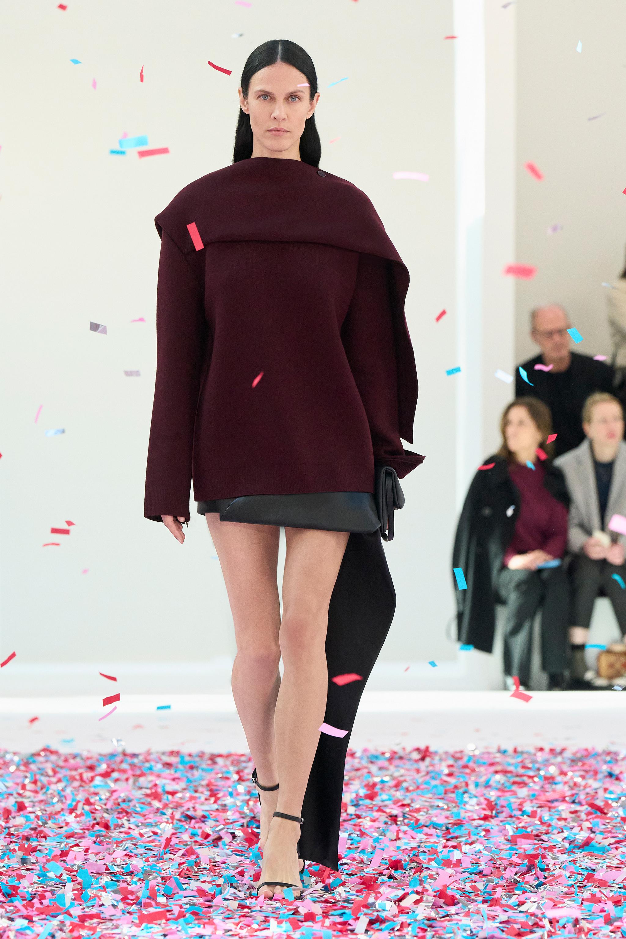 Elegant Courrèges fashion show featuring modern, minimalistic design with bold colors.