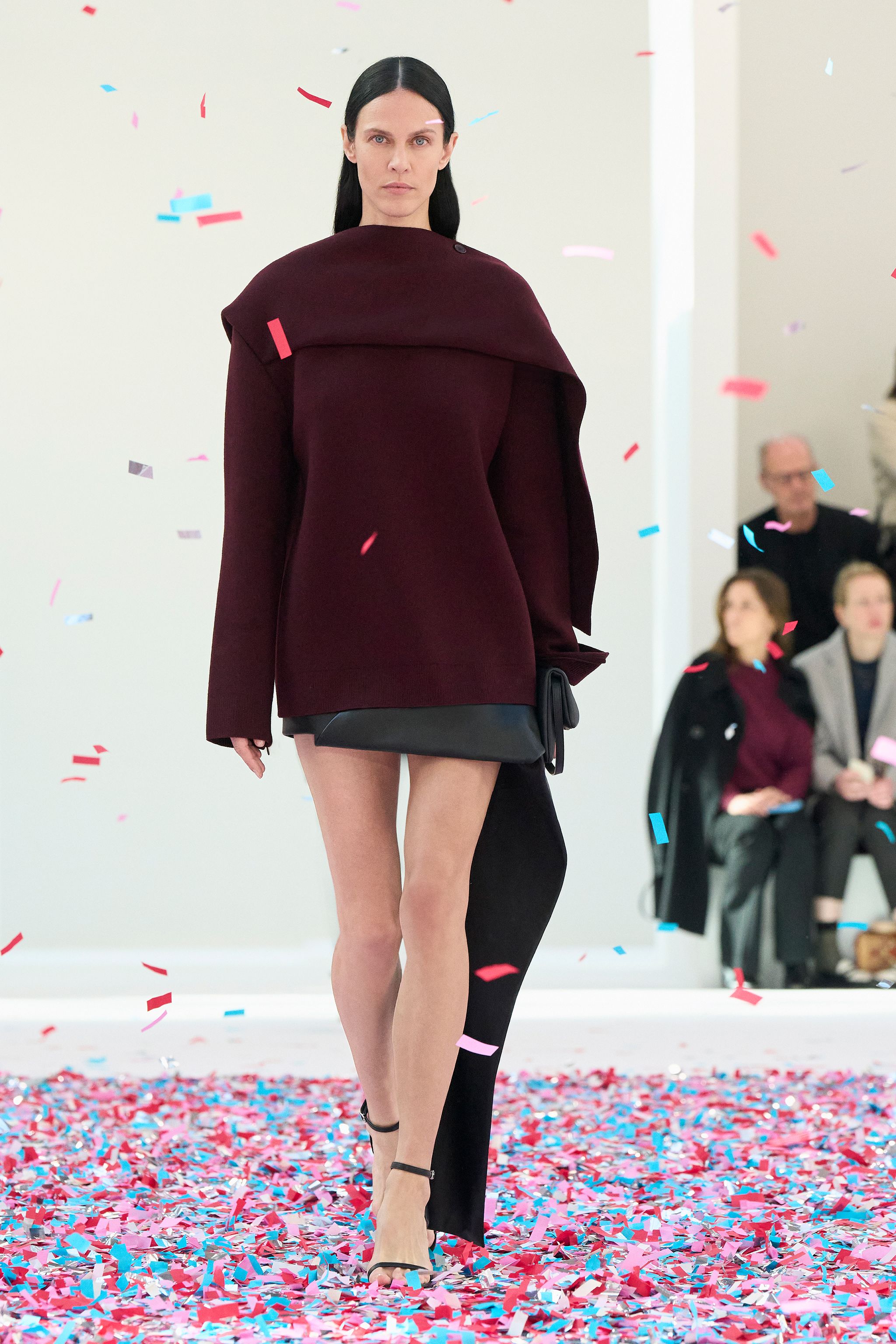 Elegant minimalist burgundy coat and black accessories by Courrèges, fashion runway.