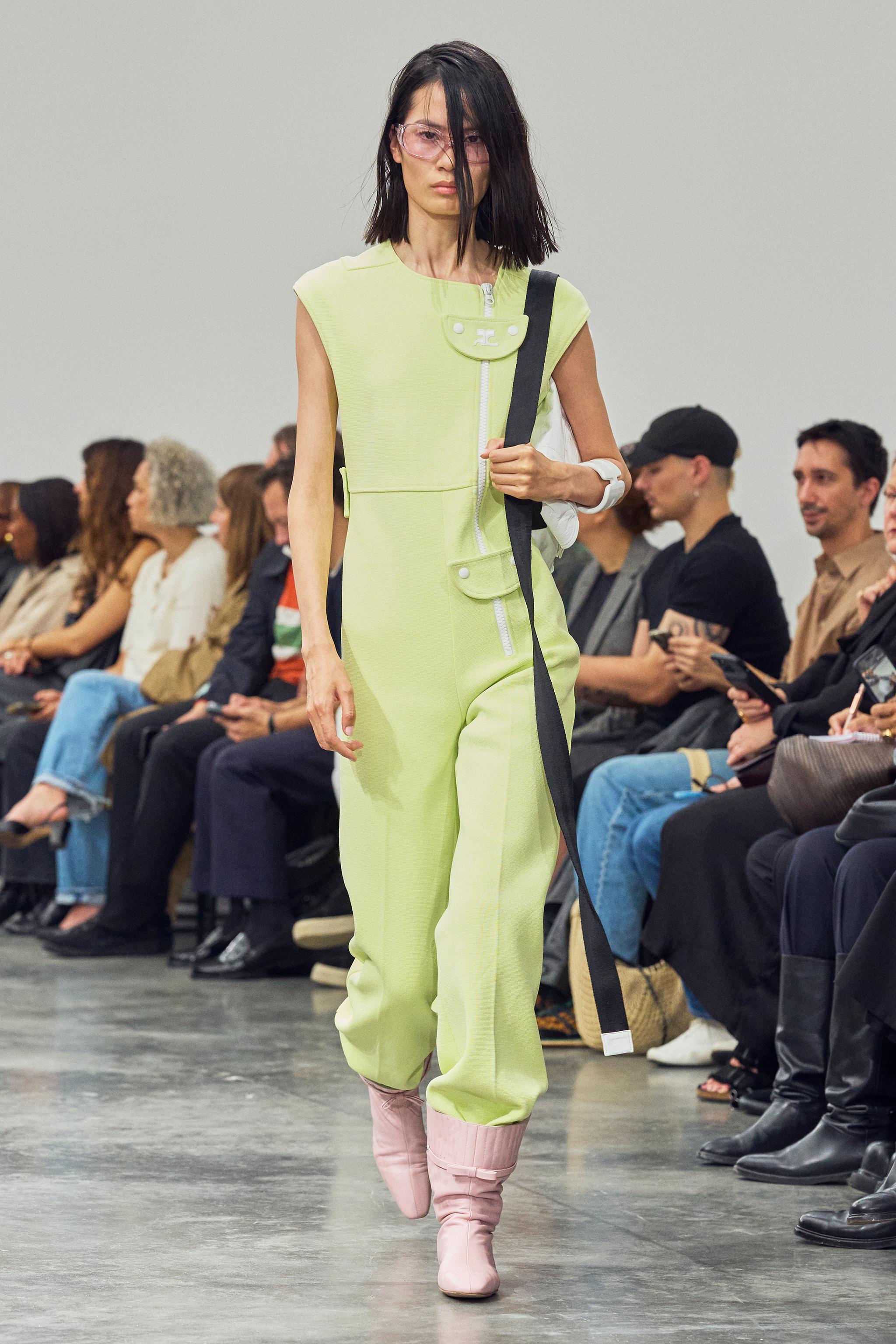 Elegant lime green jumpsuit by Courrèges on runway, showcasing futuristic fashion design.