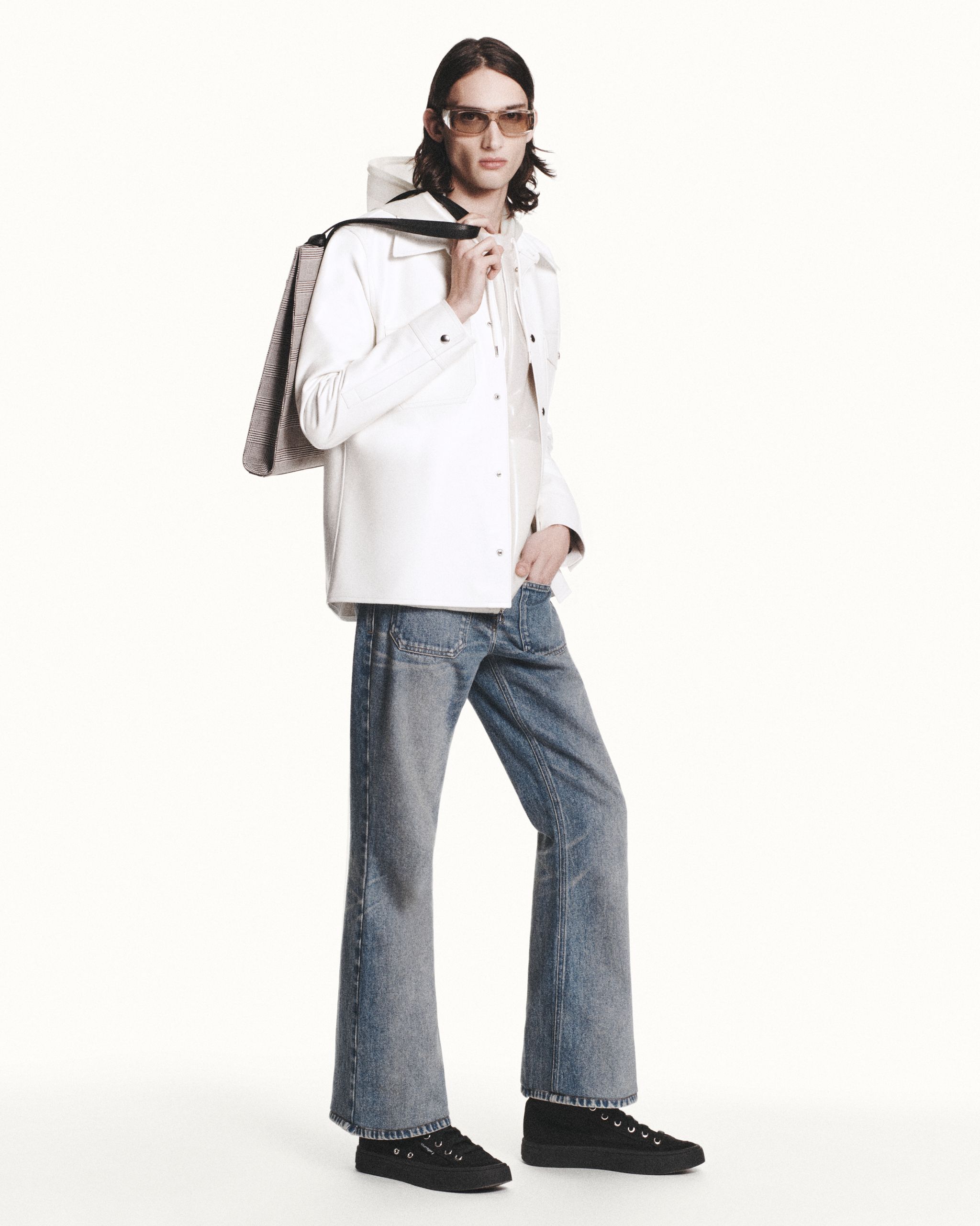 Fashionable model in casual urban wear showcasing Courrèges' modern apparel for ecommerce.