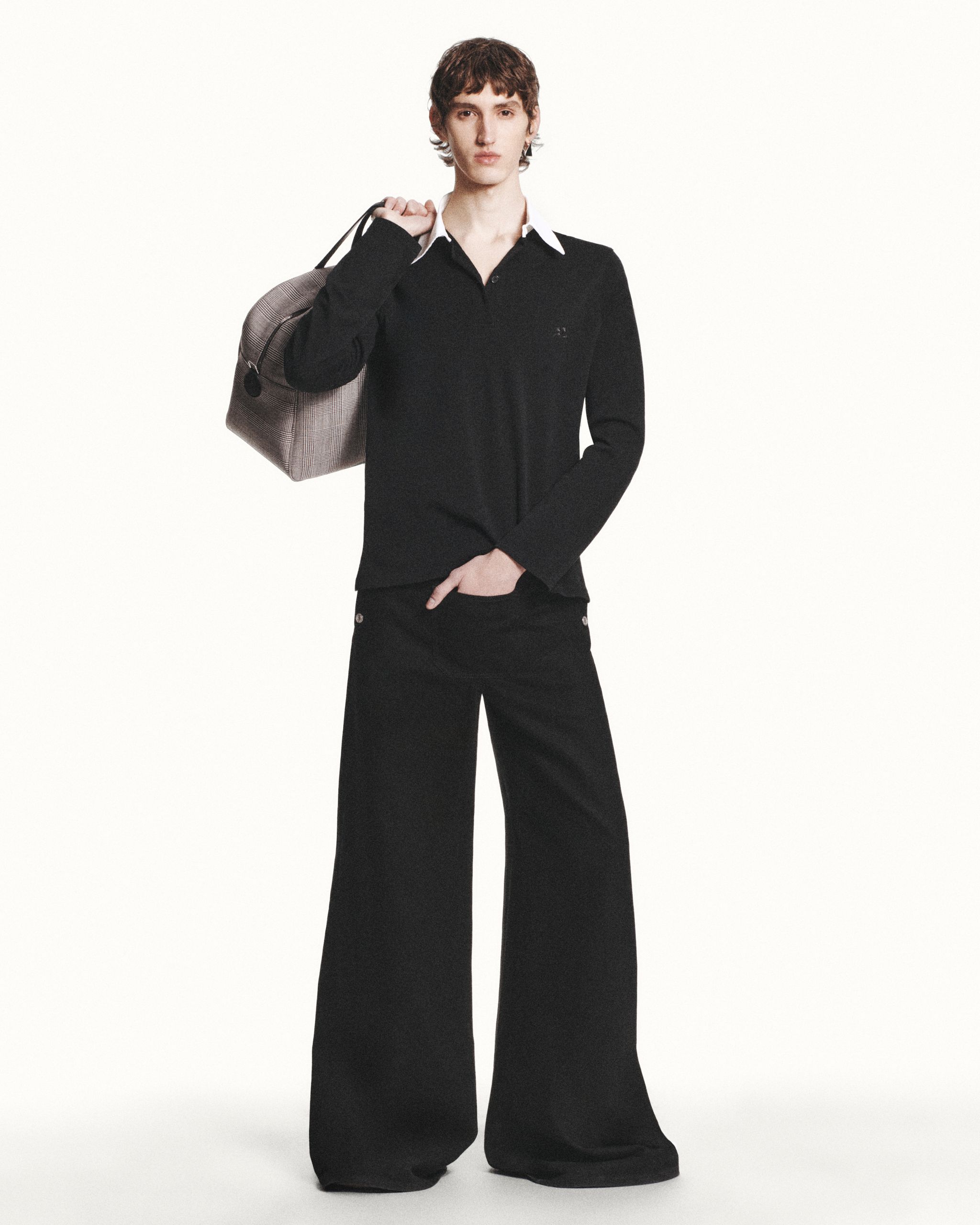 Elegant black ensemble with wide-leg trousers and a chic zip-up jacket for Courrèges.