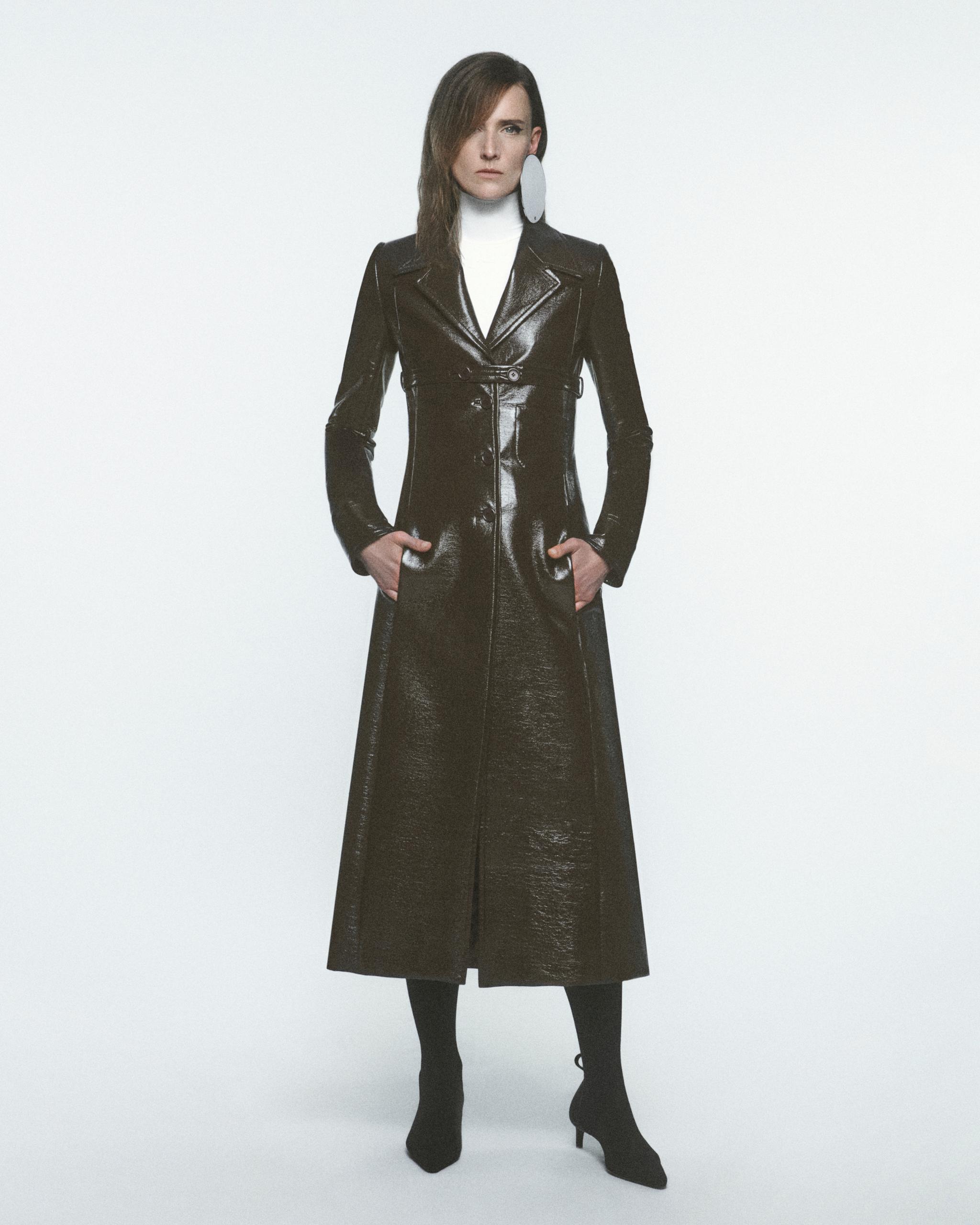 Elegant black patent leather trench coat from Courrèges, perfect for modern fashion statement.
