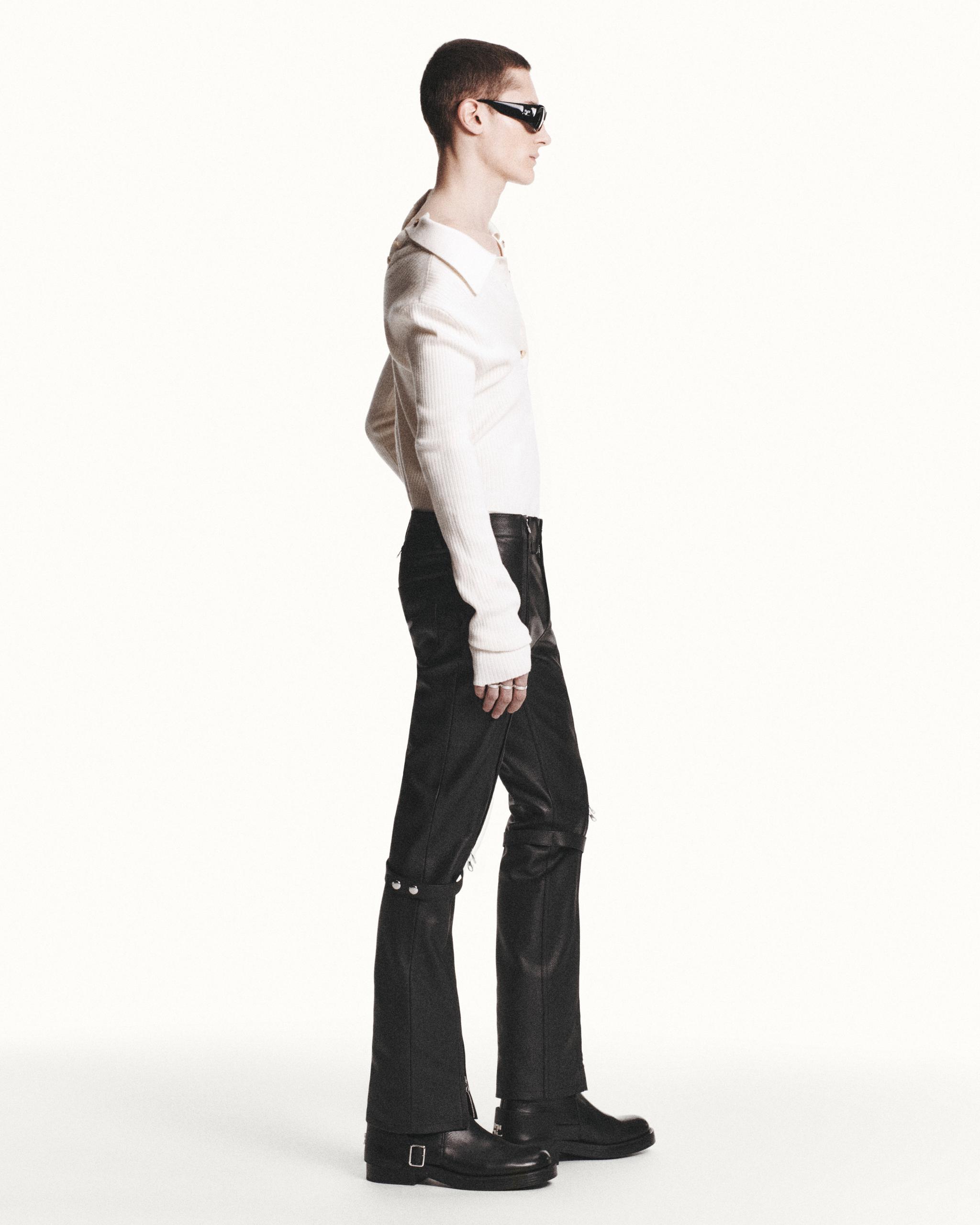Elegant model wearing Courrèges fashion with black boots and stylish sunglasses for sale.
