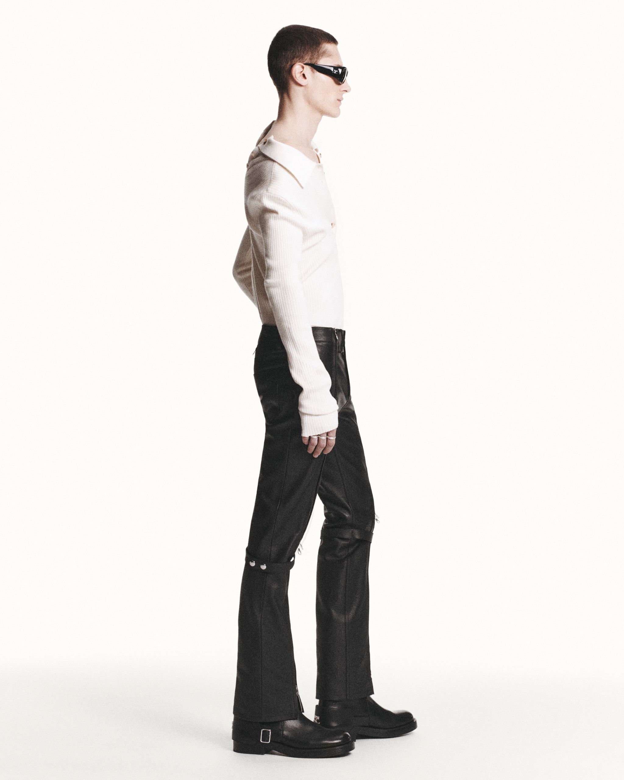 Elegant model wearing Courrèges fashion with black boots and stylish sunglasses for sale.