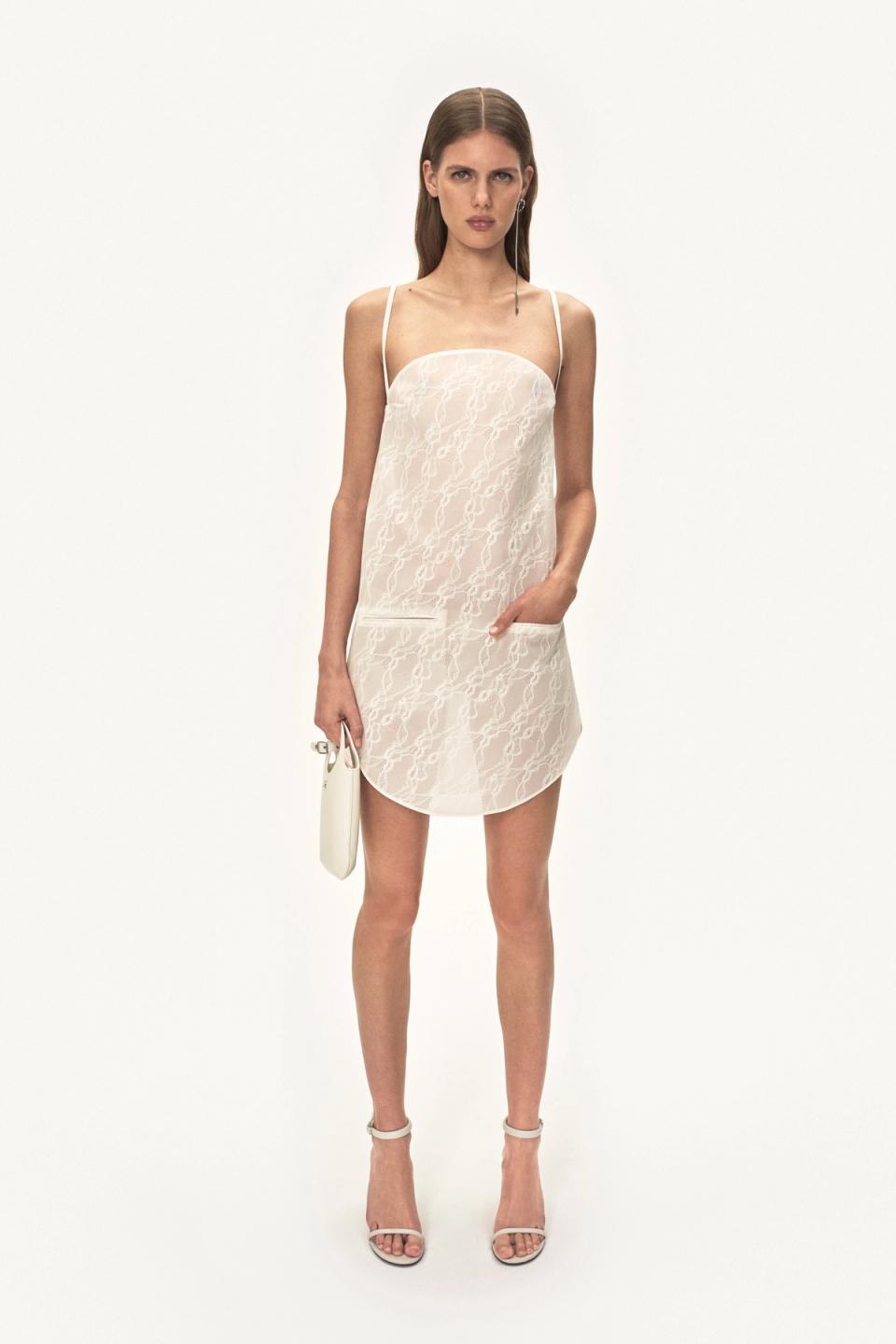 Elegant white lace slip dress with thin straps, showcasing Courrèges fashion on an ecommerce site.