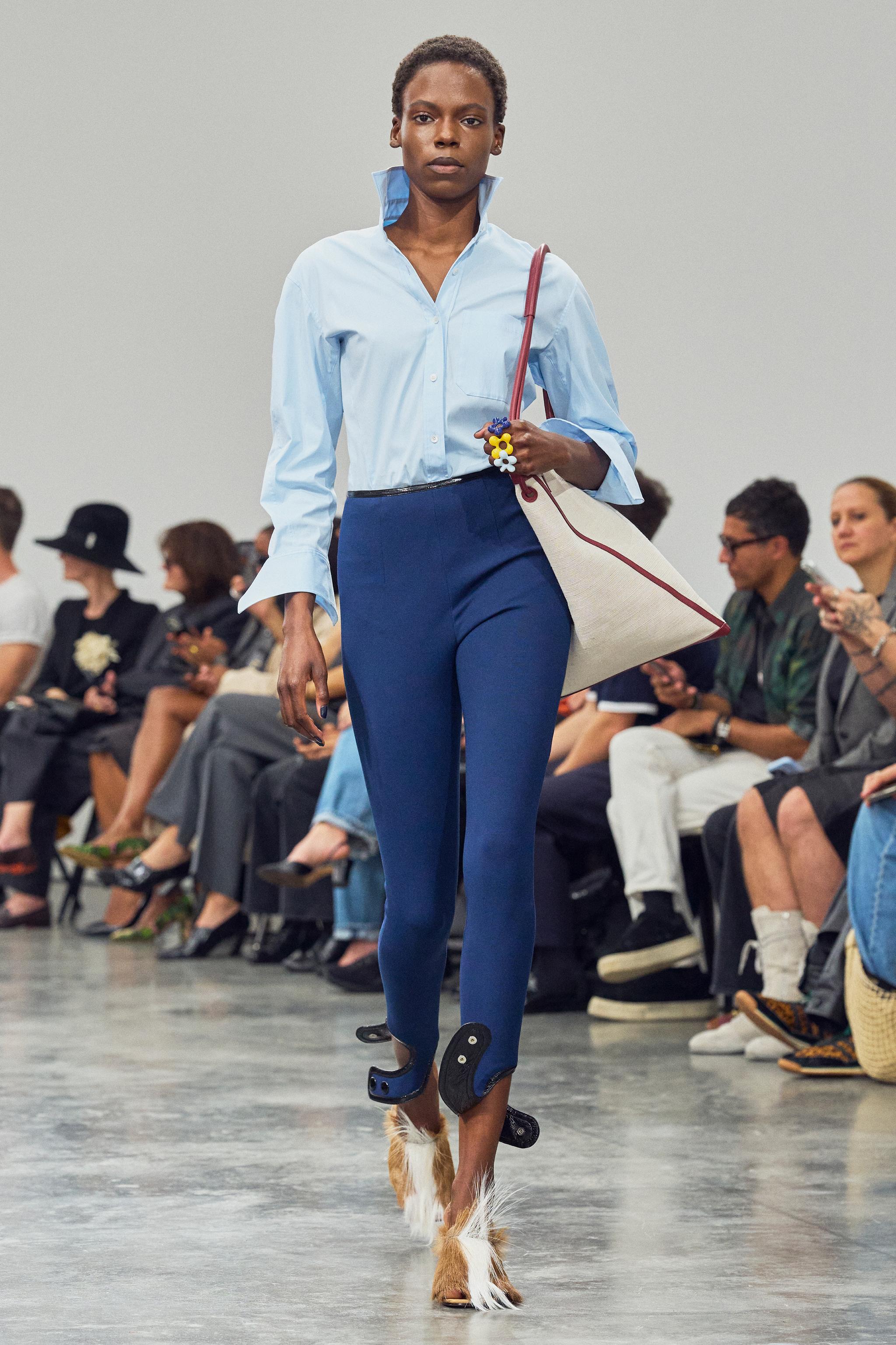 Elegant model wearing Courrèges fashion on runway, showcasing modern style and innovative design.