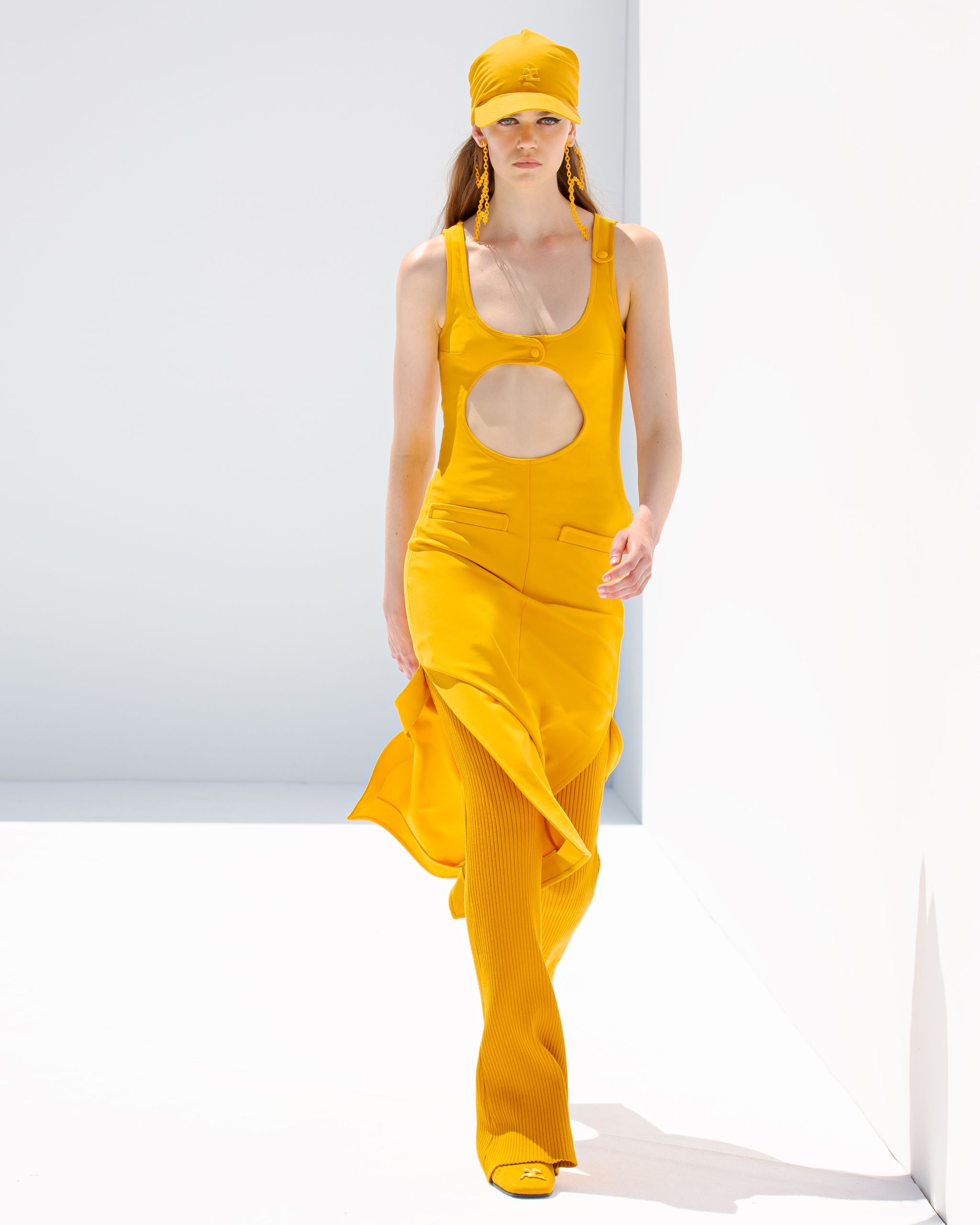 Elegant yellow cutout dress with matching accessories, showcased by Courrèges for fashion apparel.