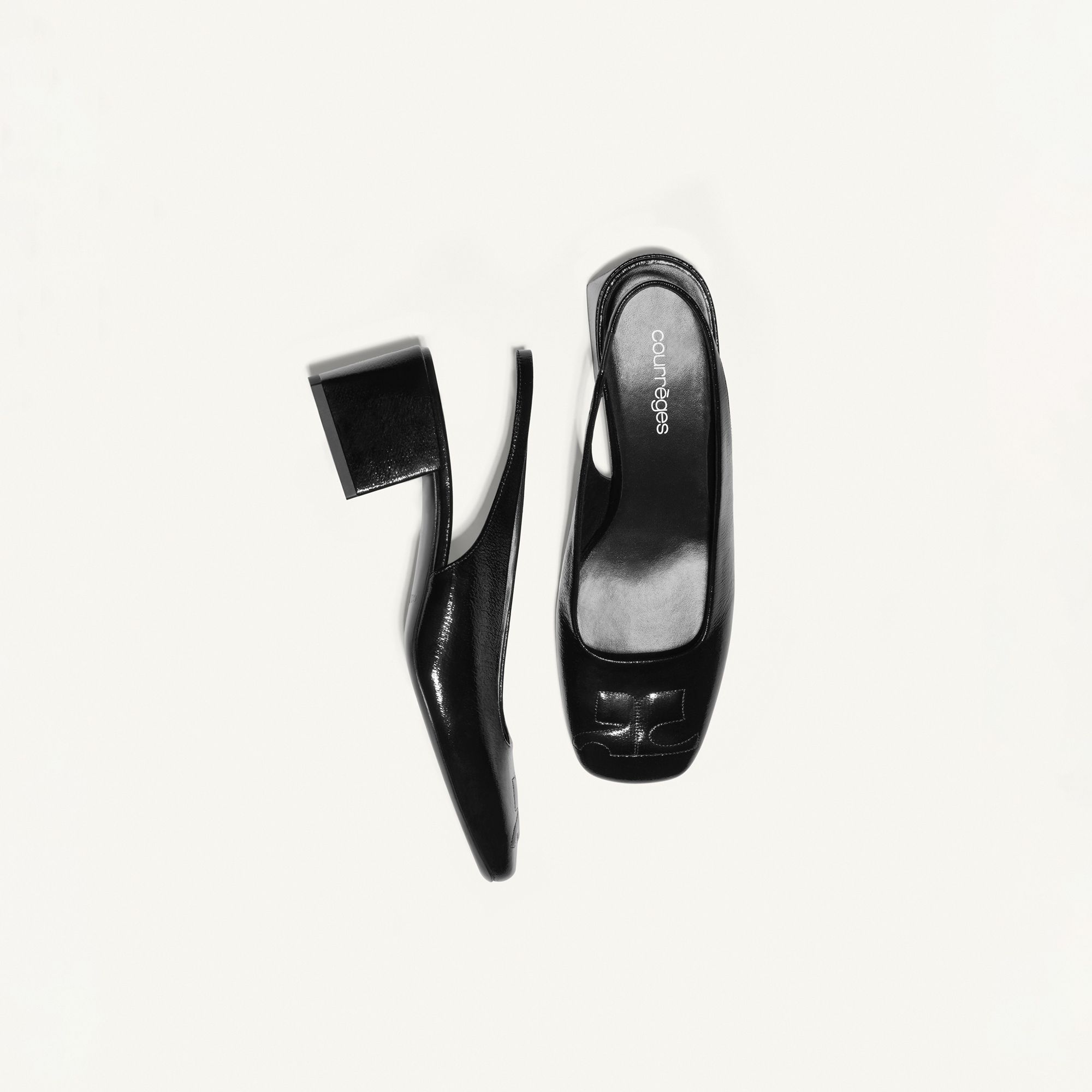 Elegant black Courrèges heels with a block heel, perfect for a fashionable look.