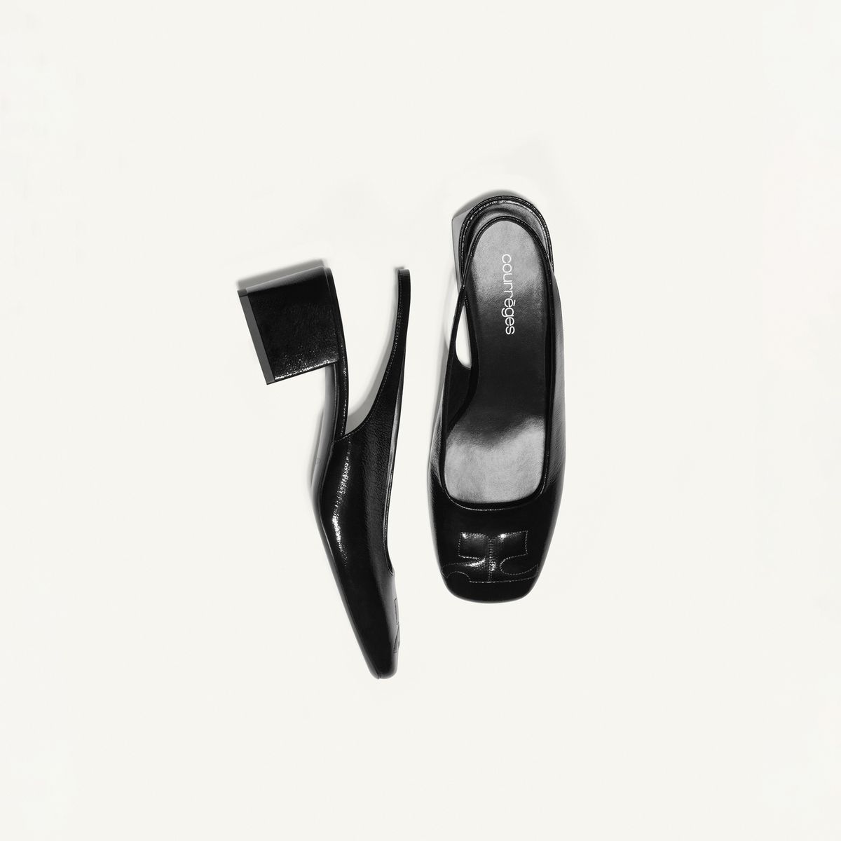 Elegant black leather high heels with a block heel, designed for Courrèges' fashion collection.