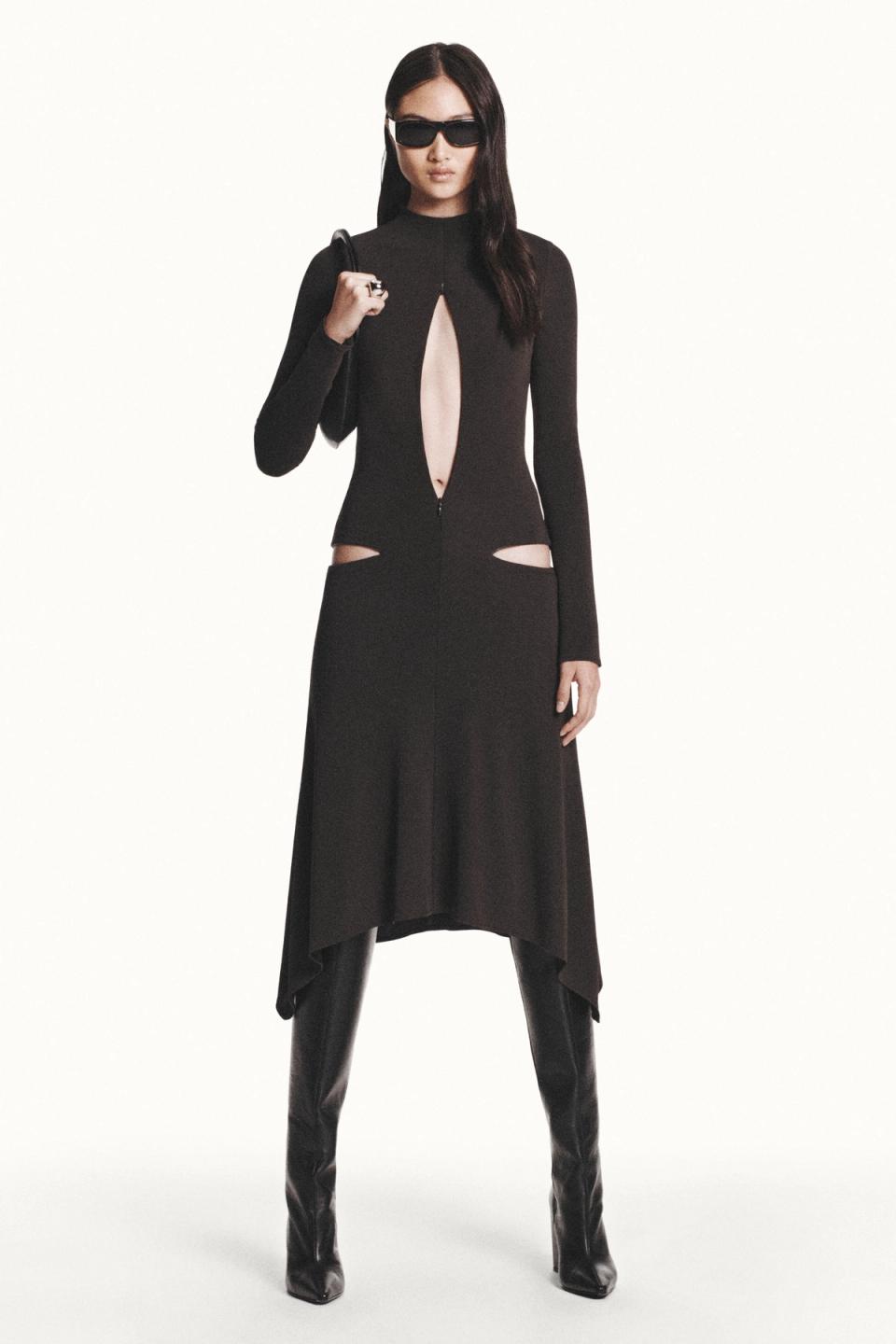 Elegant black Courrèges dress with cut-outs, long sleeves, and fashionable sunglasses.