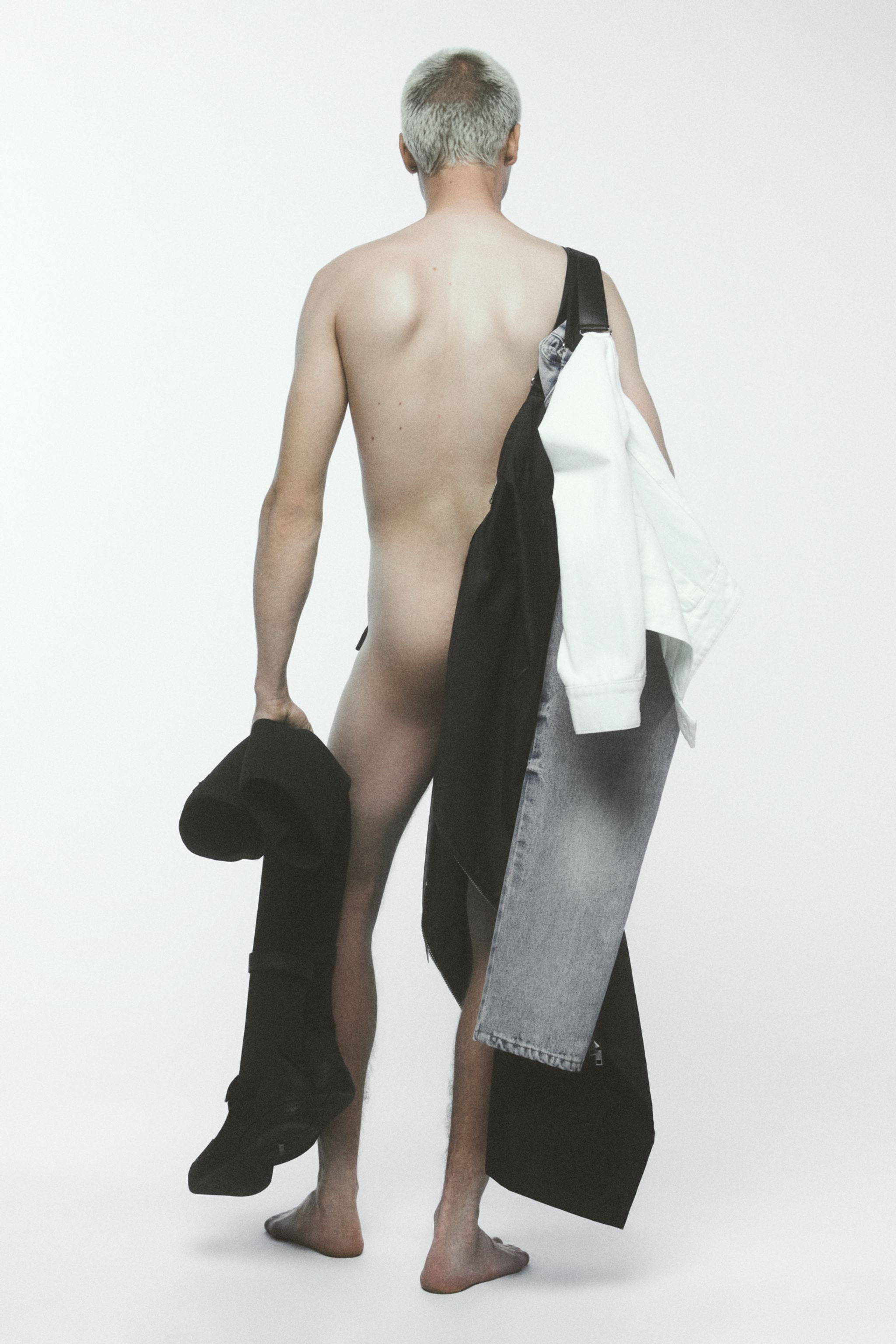 Fashion-forward model with clothing and accessories, embodying Courrèges style on a white background.