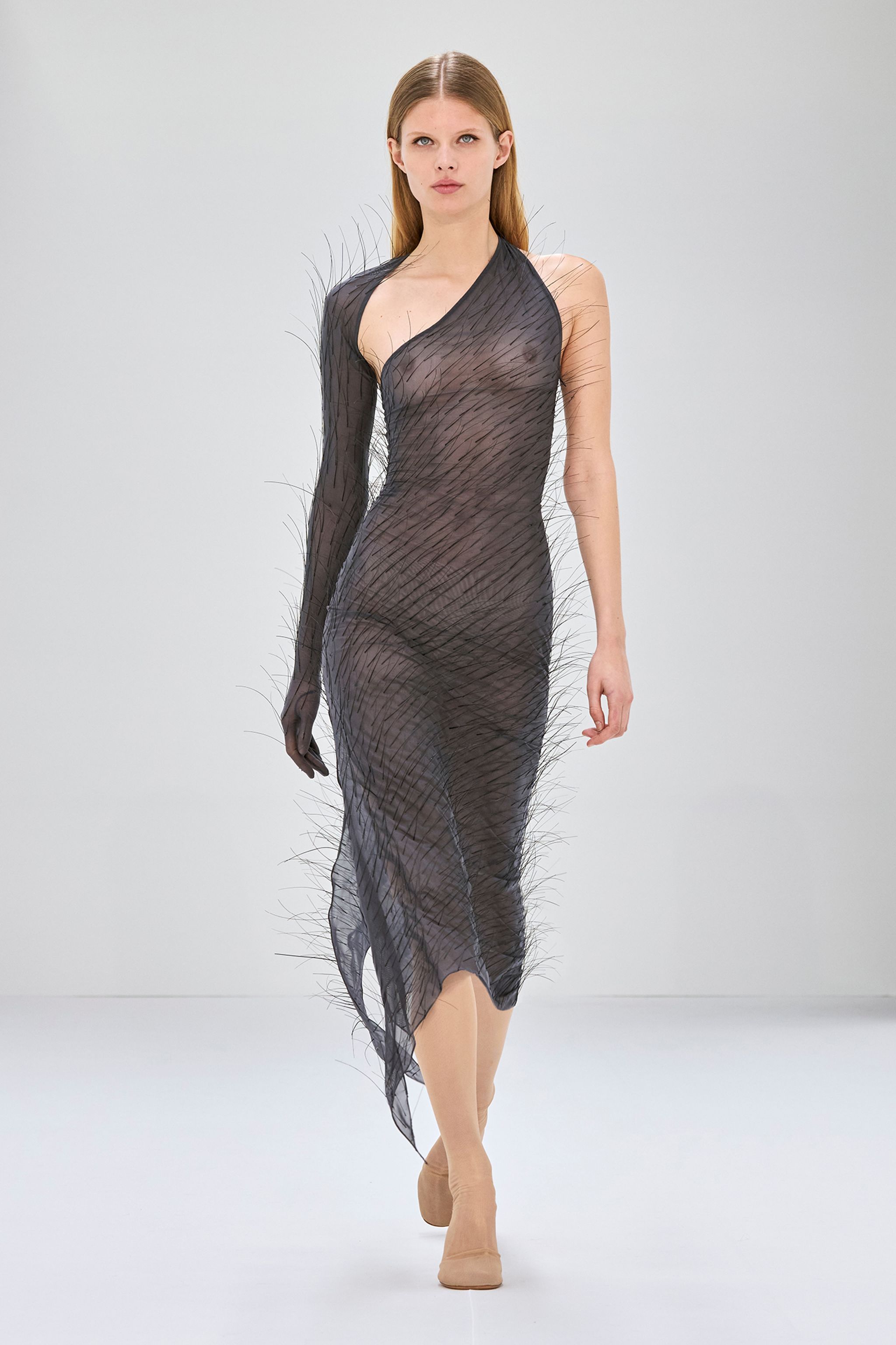 Elegant sheer dress with unique feather-like embellishments, by Courrèges, on an e-commerce website.