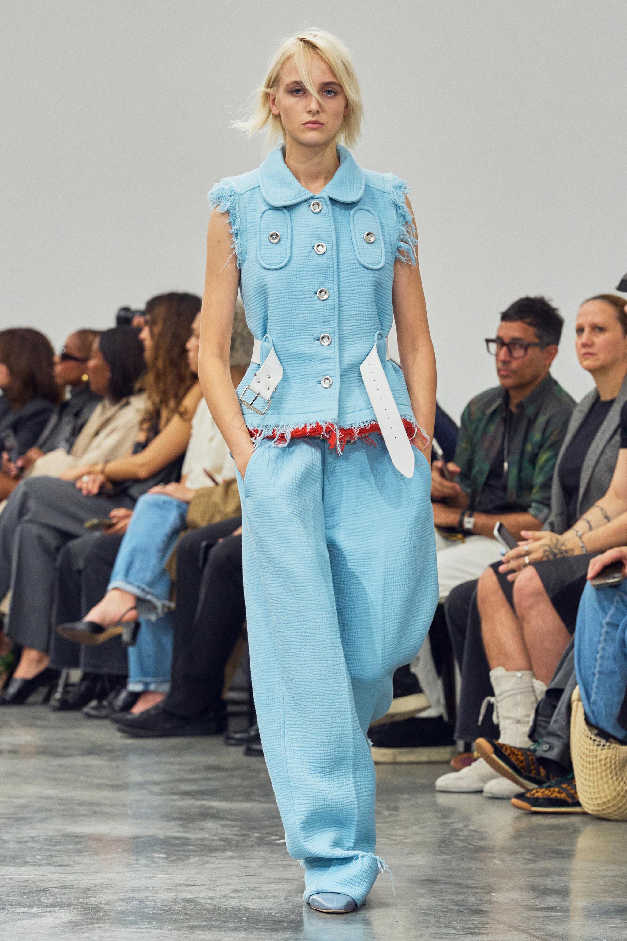 Elegant light blue fashion ensemble with distressed details, showcased at Courrèges runway.